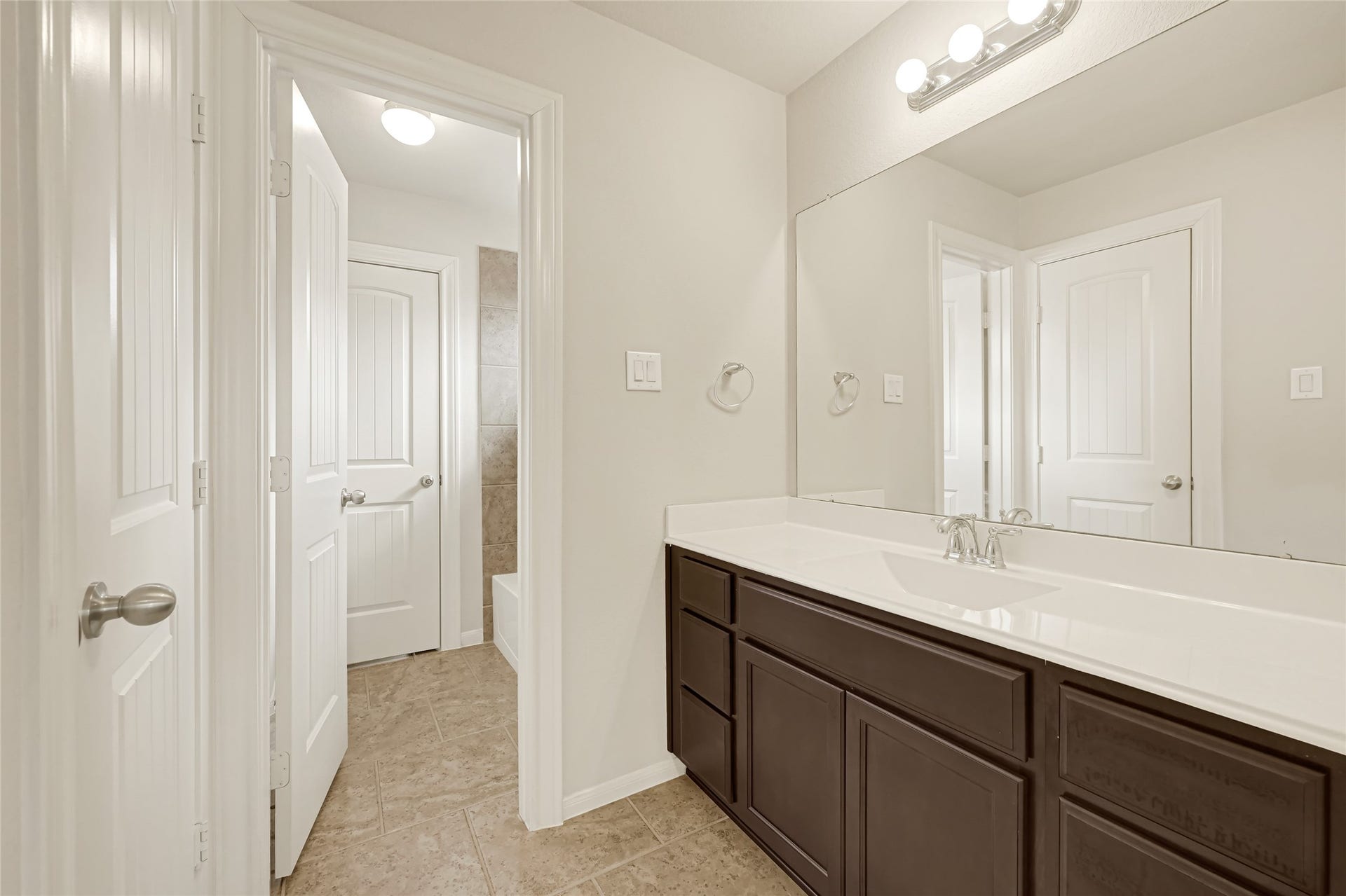 736 Somerset Landing Lane, League City, TX 77573 Well-appointed vanity with dark cabinetry, generous counter space, and access to the adjoining bath area.
