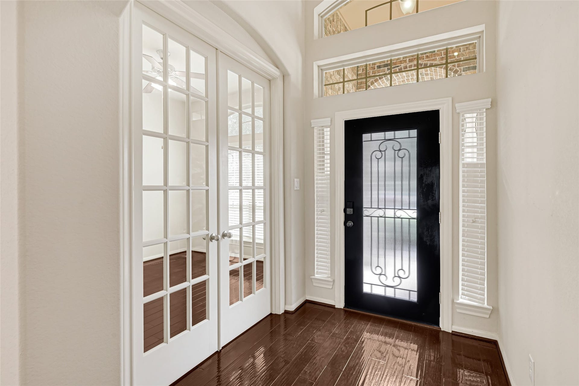 736 Somerset Landing Lane, League City, TX 77573 Elegant foyer with French doors, hardwood flooring, and a decorative glass front door.
