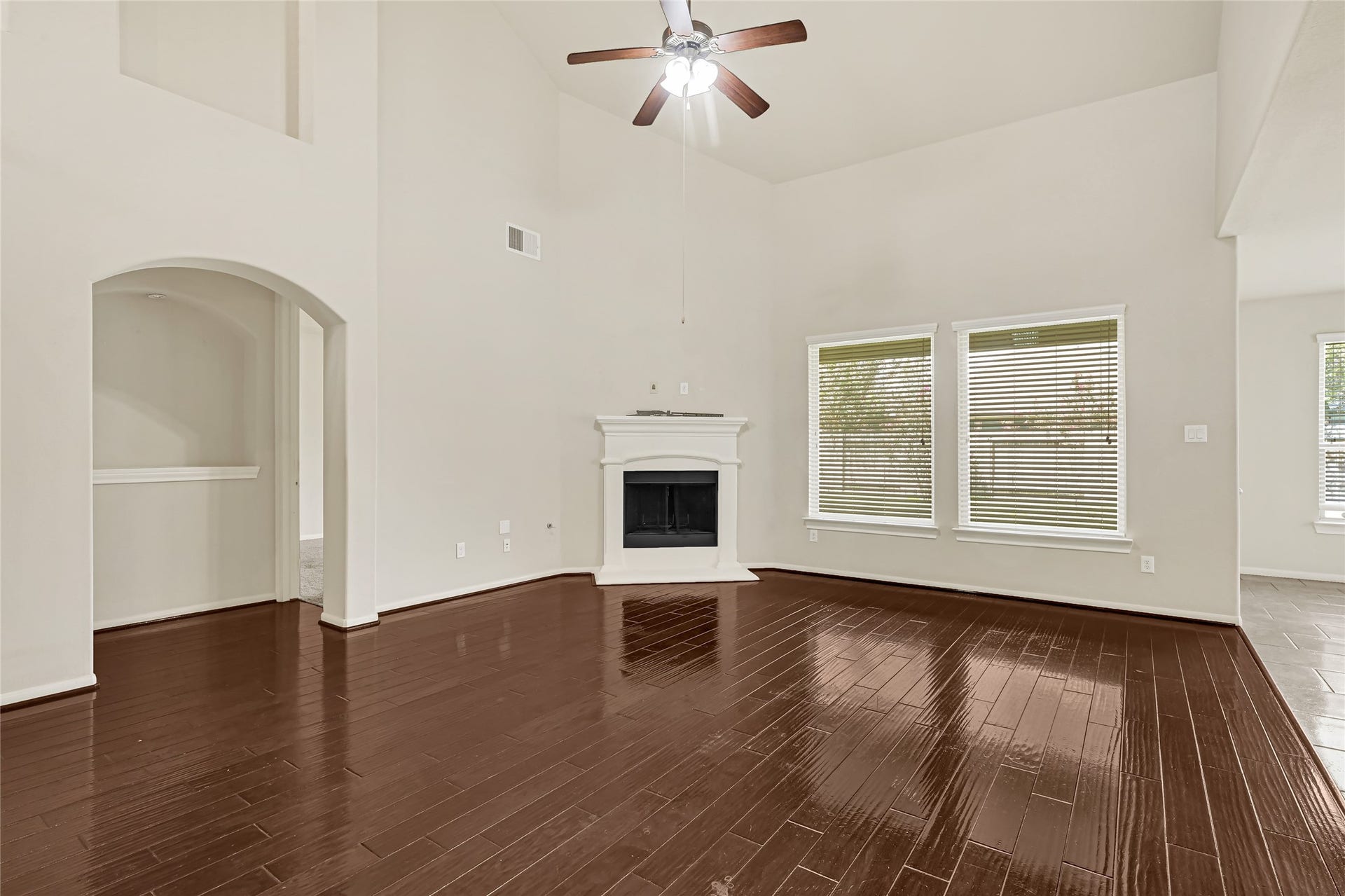 736 Somerset Landing Lane, League City, TX 77573 Formal dining room with hardwood flooring, crown molding, and an arched opening to the foyer.