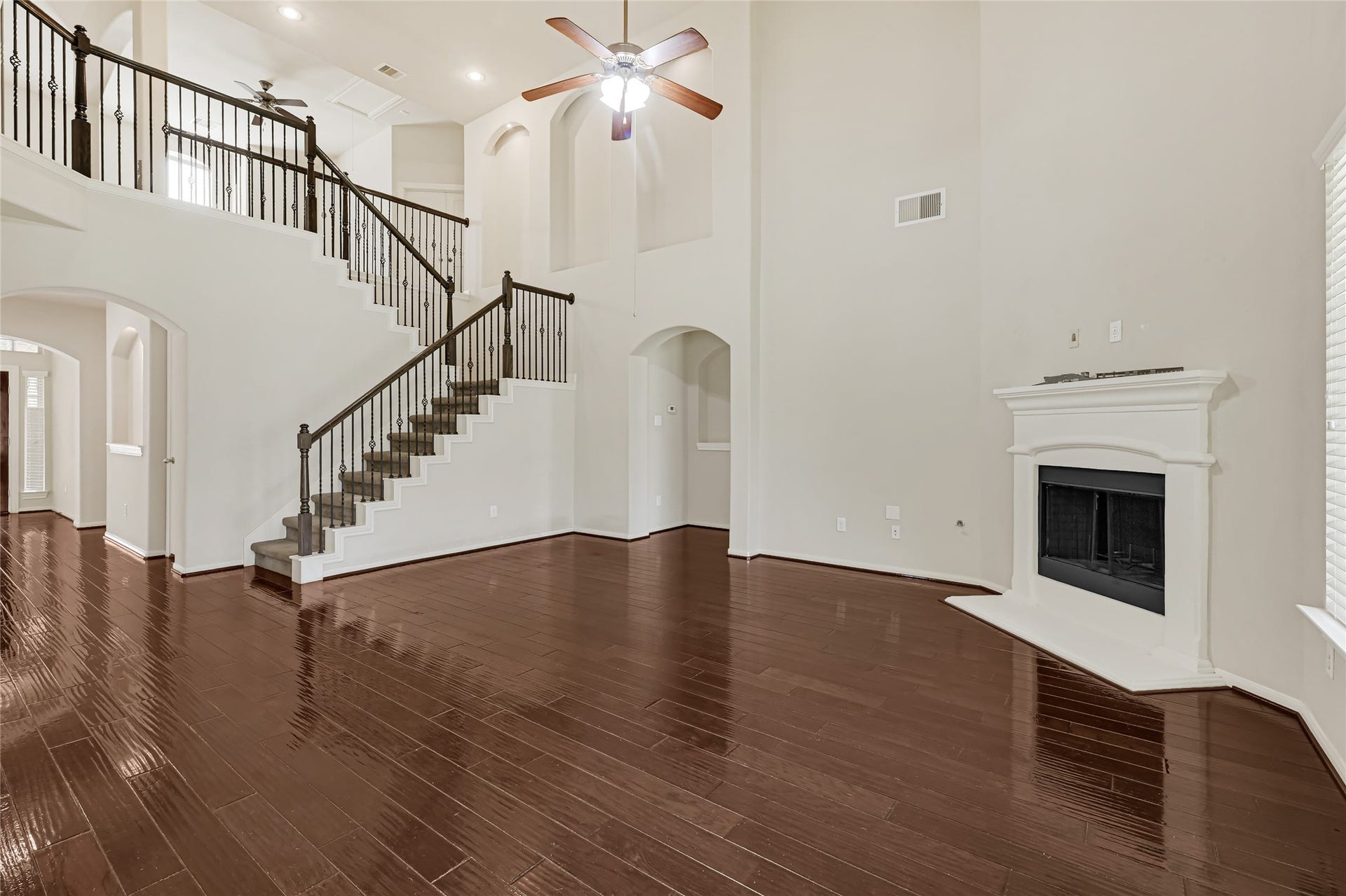 736 Somerset Landing Lane, League City, TX 77573 Welcoming foyer with rich hardwood flooring, an open staircase, and bright neutral finishes.