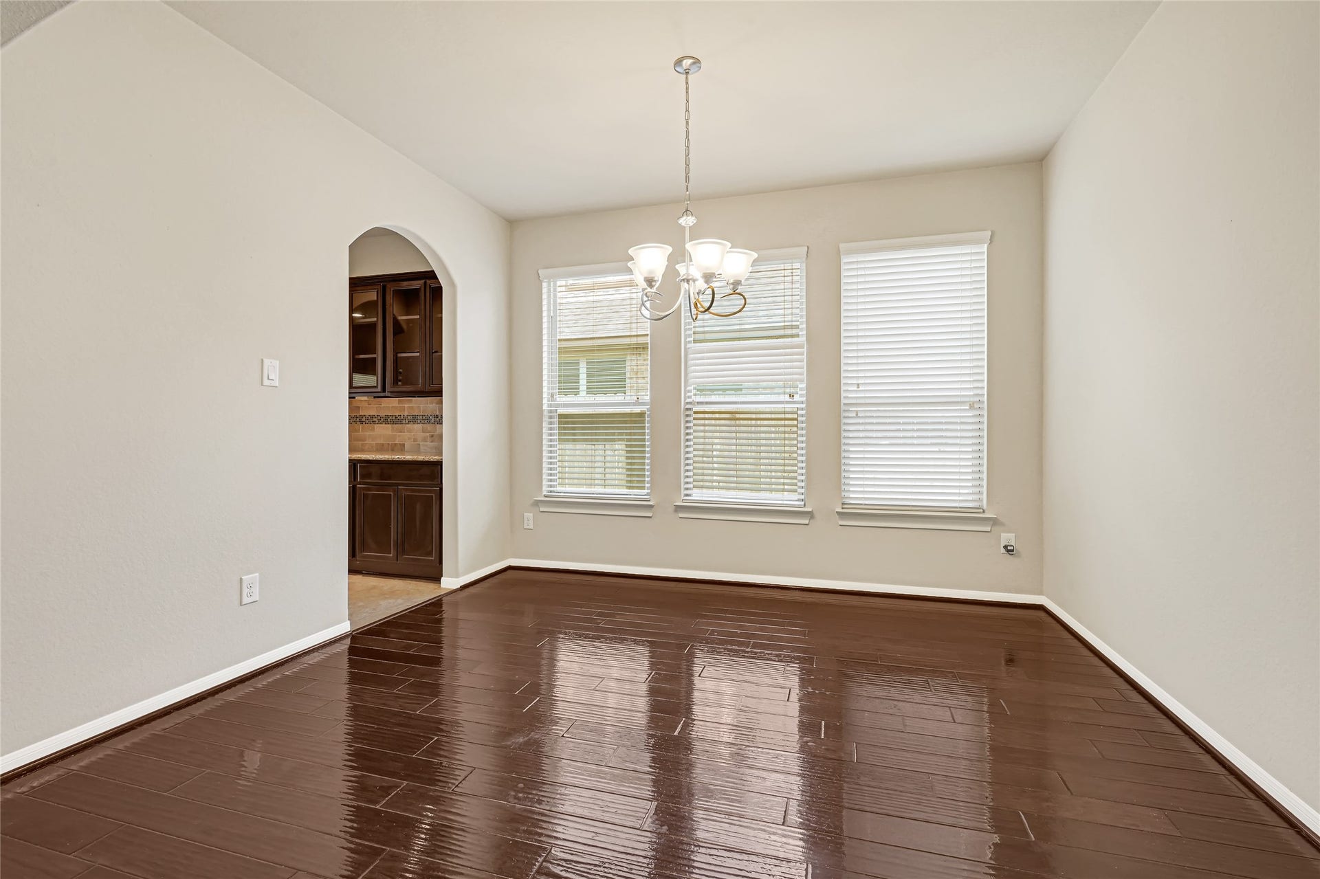 736 Somerset Landing Lane, League City, TX 77573 Generously sized dining room with hardwood flooring, neutral finishes, and large windows.