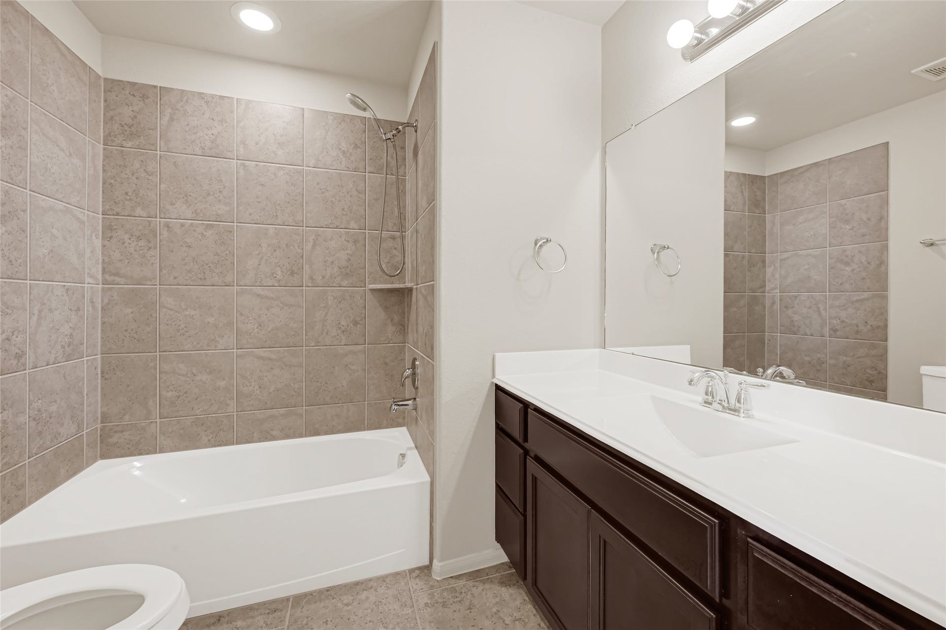 736 Somerset Landing Lane, League City, TX 77573 Full bathroom with a tub-and-shower combination, tiled surround, and an extended vanity.