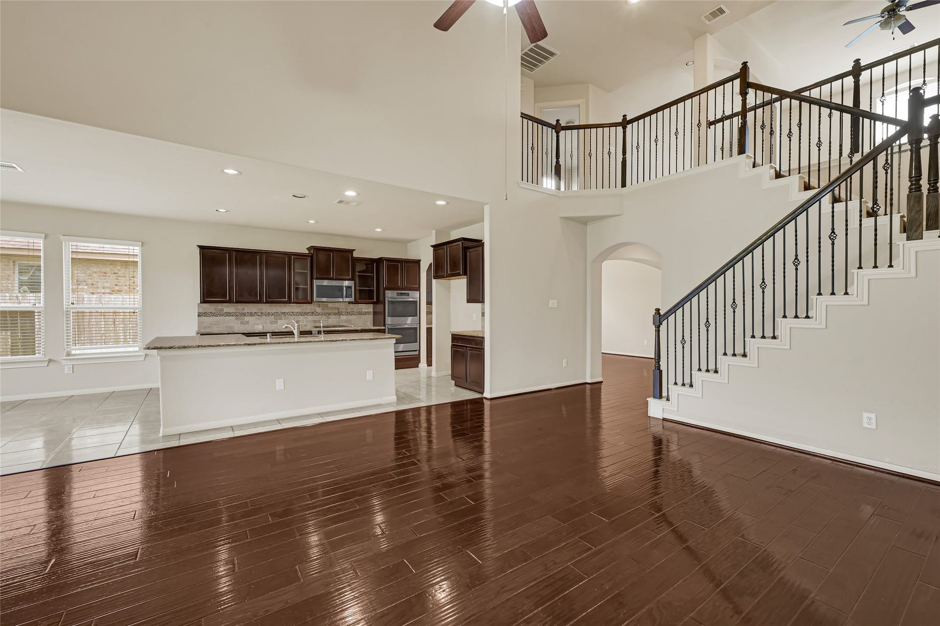 736 Somerset Landing Lane, League City, TX 77573 Open-concept living space connecting the kitchen, dining area, and staircase.