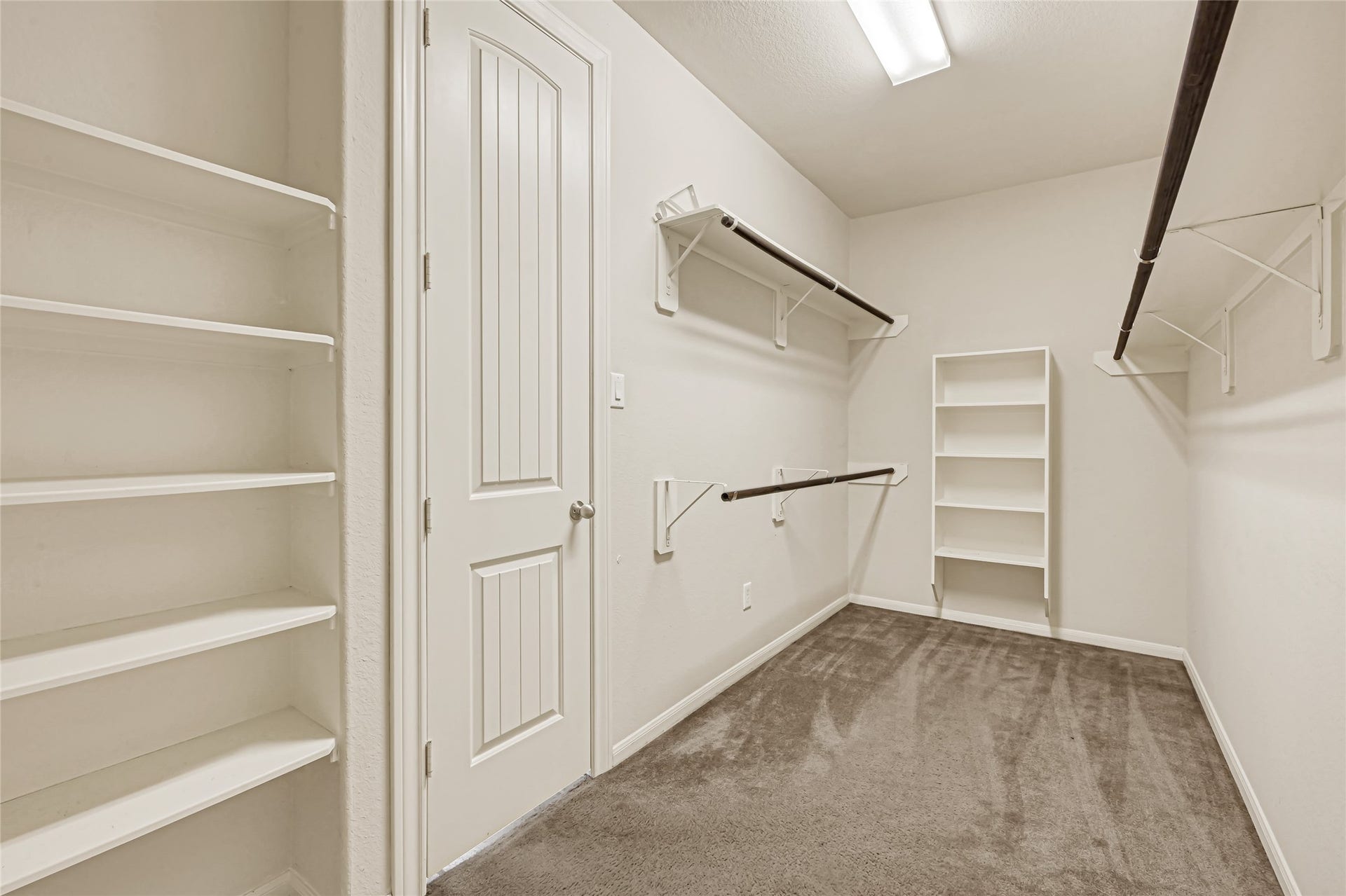736 Somerset Landing Lane, League City, TX 77573 Large walk-in closet with built-in shelving, drawers, and organized storage.