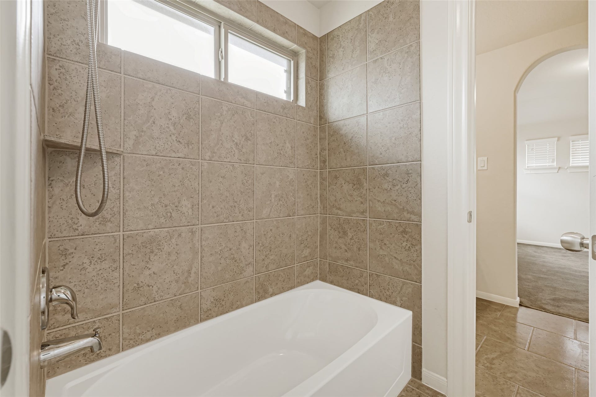 736 Somerset Landing Lane, League City, TX 77573 Full bathroom with a tub-and-shower combination, tiled surround, and natural light.