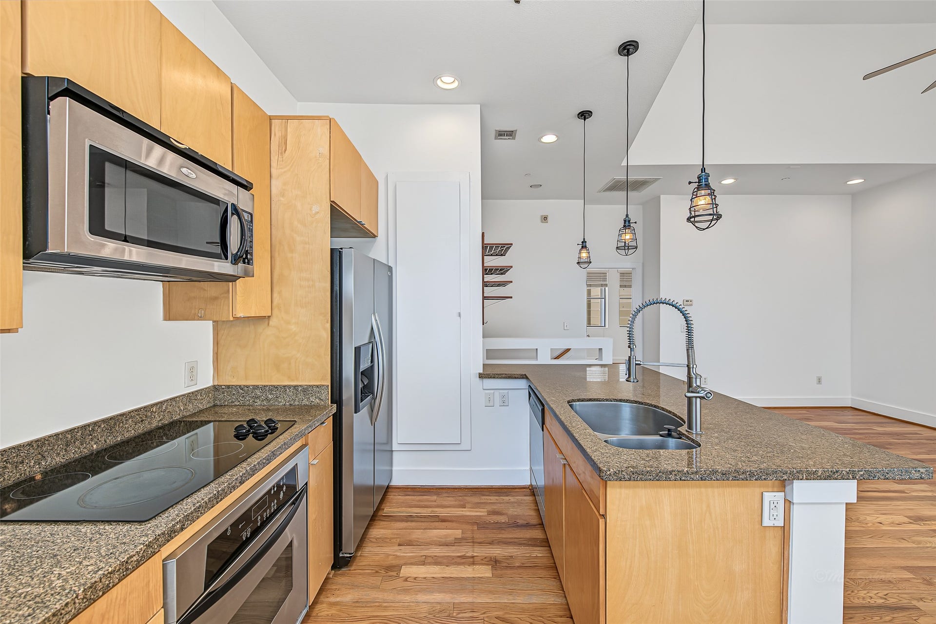 1555 Birdsall Street, #A, Houston, TX 77007 Imagine preparing meals on the large granite island, chatting with guests seated at the breakfast bar, and pouring a glass from your built-in wine display.