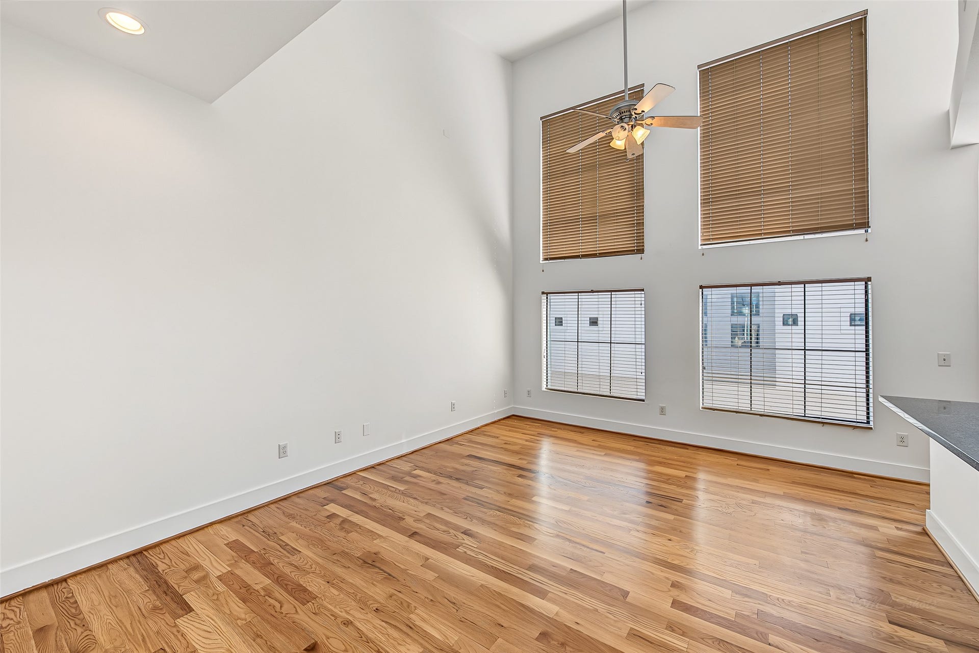 1555 Birdsall Street, #A, Houston, TX 77007 The heart of the home features a breathtaking two-story living room with soaring vaulted ceilings and stacked double-height windows that bathe the space in natural light.