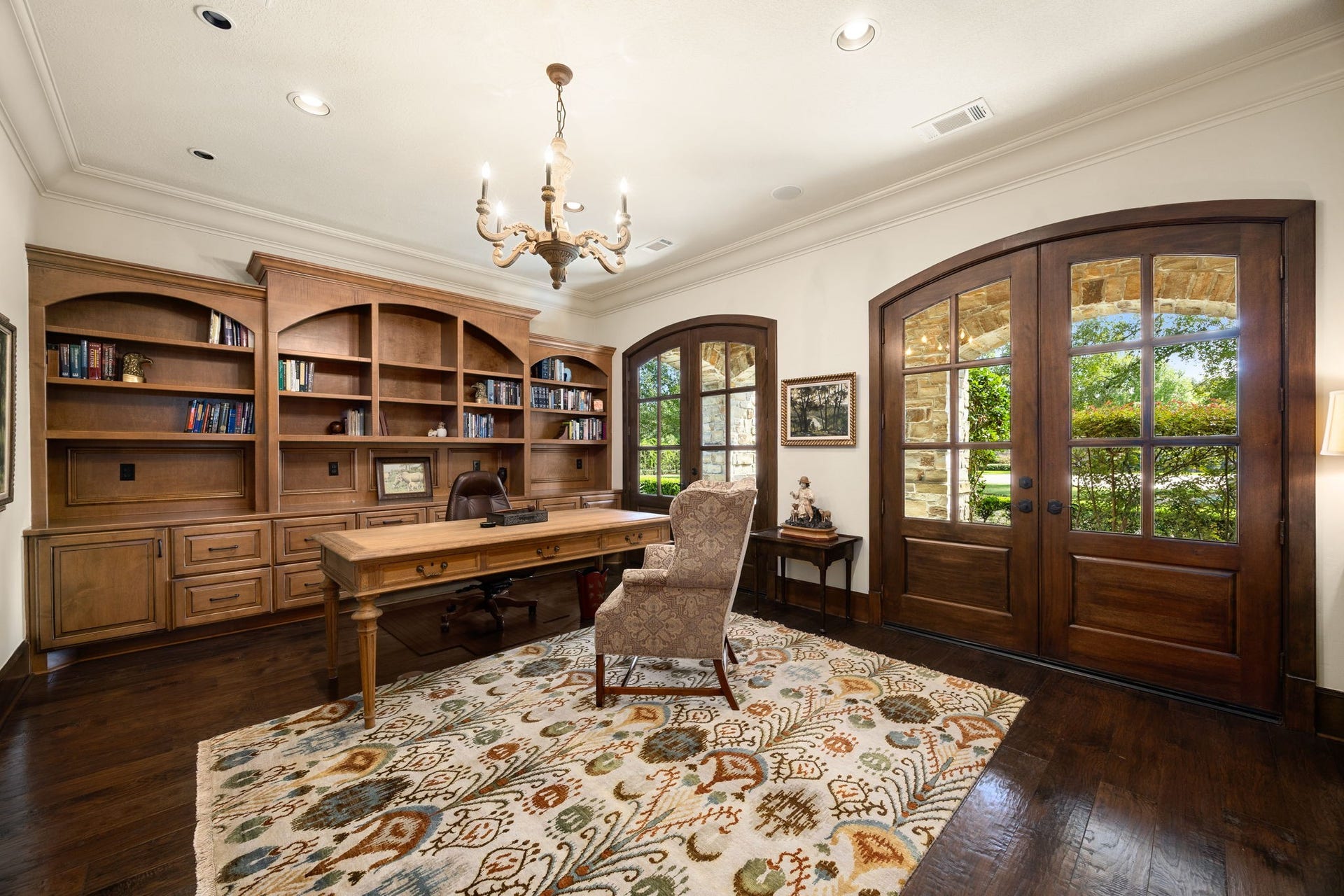 2127 Fawn Meadow Lane, Richmond, TX 77406 Sophisticated home office with extensive built-in shelving and beautiful wood finishes.