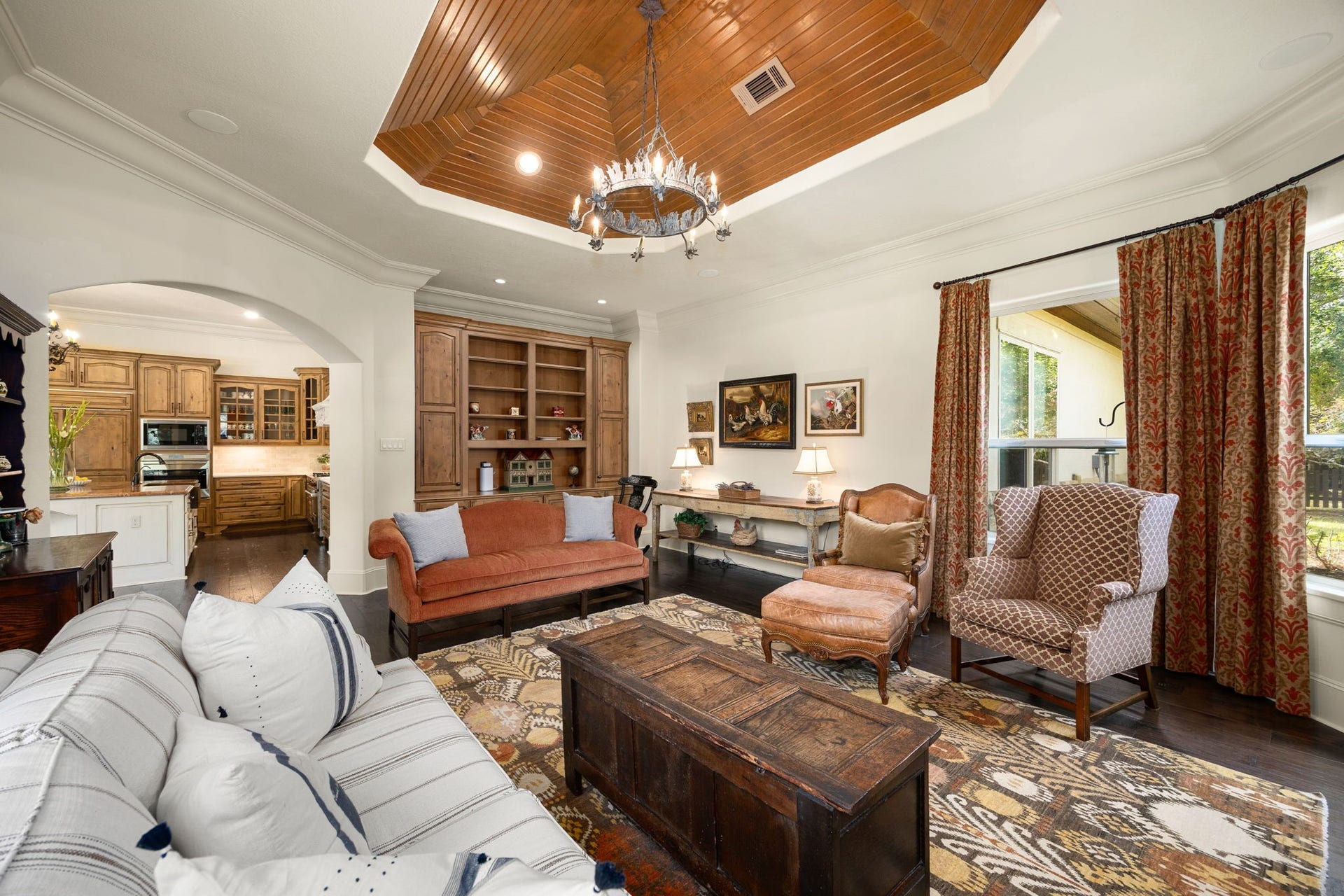 2127 Fawn Meadow Lane, Richmond, TX 77406 Spacious family room featuring warm wood ceiling details and built-in cabinetry and shelving.