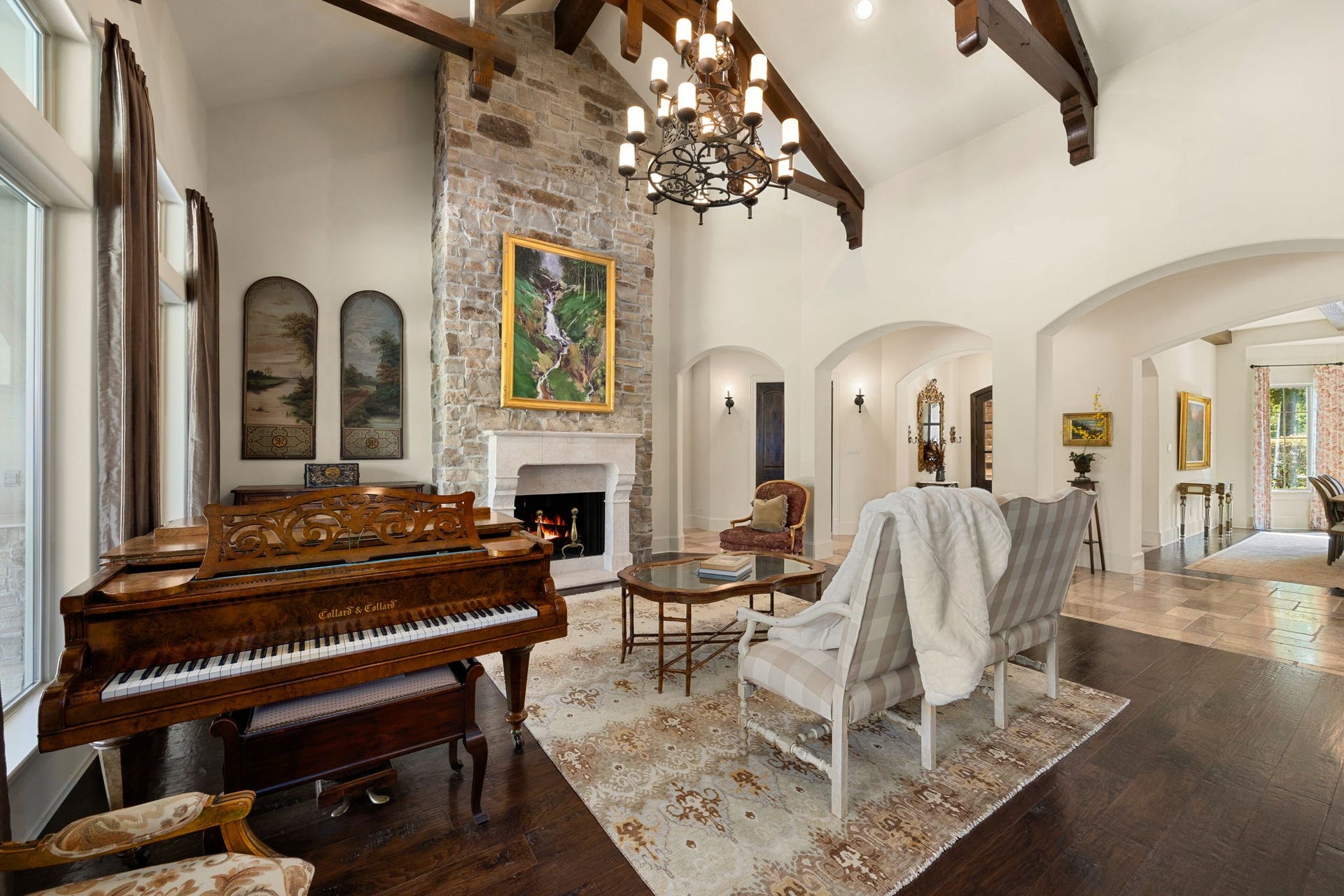 2127 Fawn Meadow Lane, Richmond, TX 77406 Elegant formal living area with beautiful natural light and architectural details such as the cathedral style beams and stone fireplace.