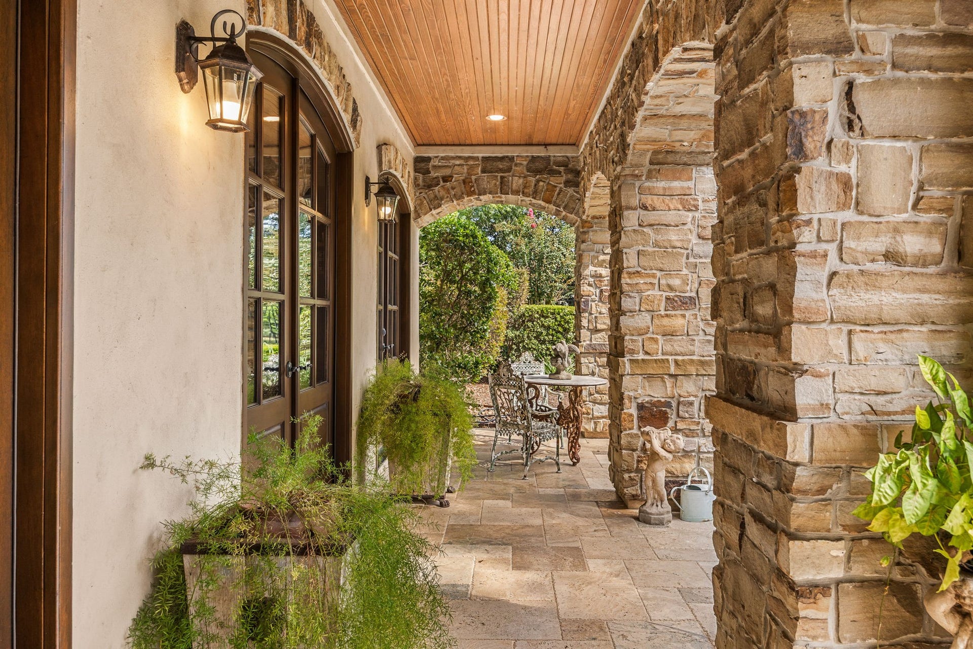 2127 Fawn Meadow Lane, Richmond, TX 77406 Charming covered entry with pine ceiling, stone accents, French doors to the study, and beautiful architectural details.