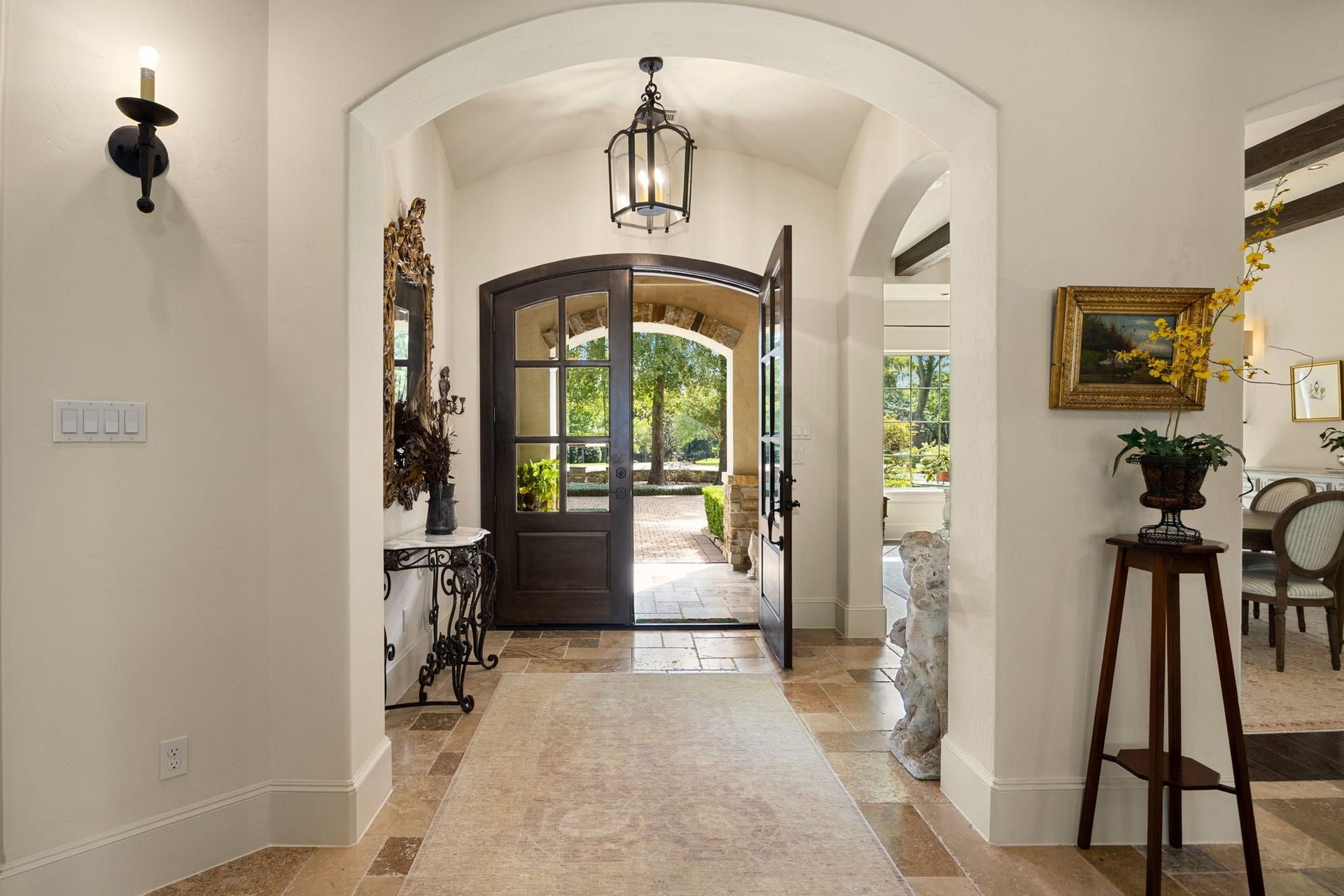 2127 Fawn Meadow Lane, Richmond, TX 77406 Grand entryway featuring arches, travertine flooring, and elegant lighting with an abundance of natural light.
