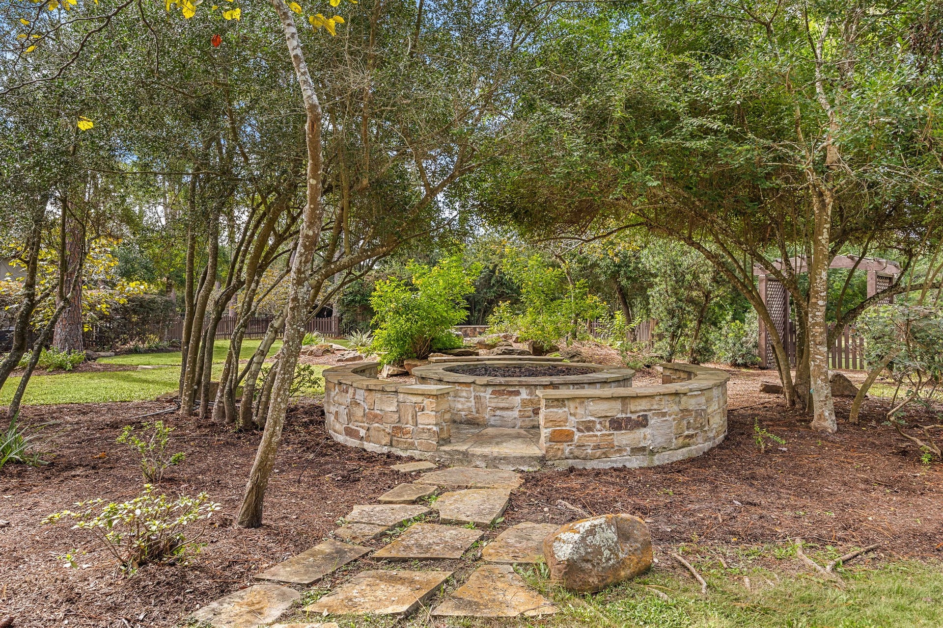 2127 Fawn Meadow Lane, Richmond, TX 77406 Just off the pool, enjoy the stone fire pit on a nice cool evening with seating all the way around.