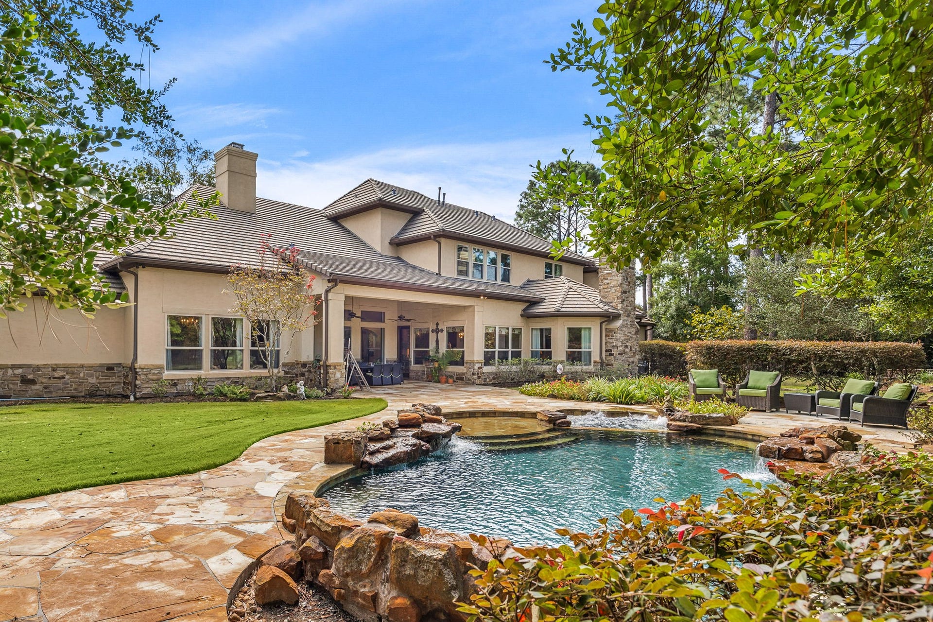 2127 Fawn Meadow Lane, Richmond, TX 77406 Stunning rear elevation showcasing the swimming pool, outdoor living spaces, and expansive home.