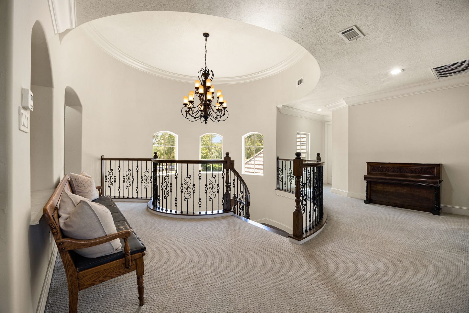 2127 Fawn Meadow Lane, Richmond, TX 77406 Spacious upstairs landing with rotunda, arched windows, an open layout and elegant chandelier.