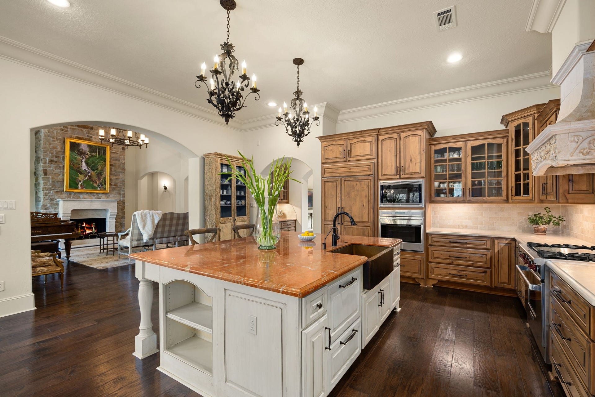 2127 Fawn Meadow Lane, Richmond, TX 77406 Another view of the kitchen showcasing custom wood cabinetry including paneled dishwasher, apron front under mount copper sink, granite countertops, and top of the line appliances.