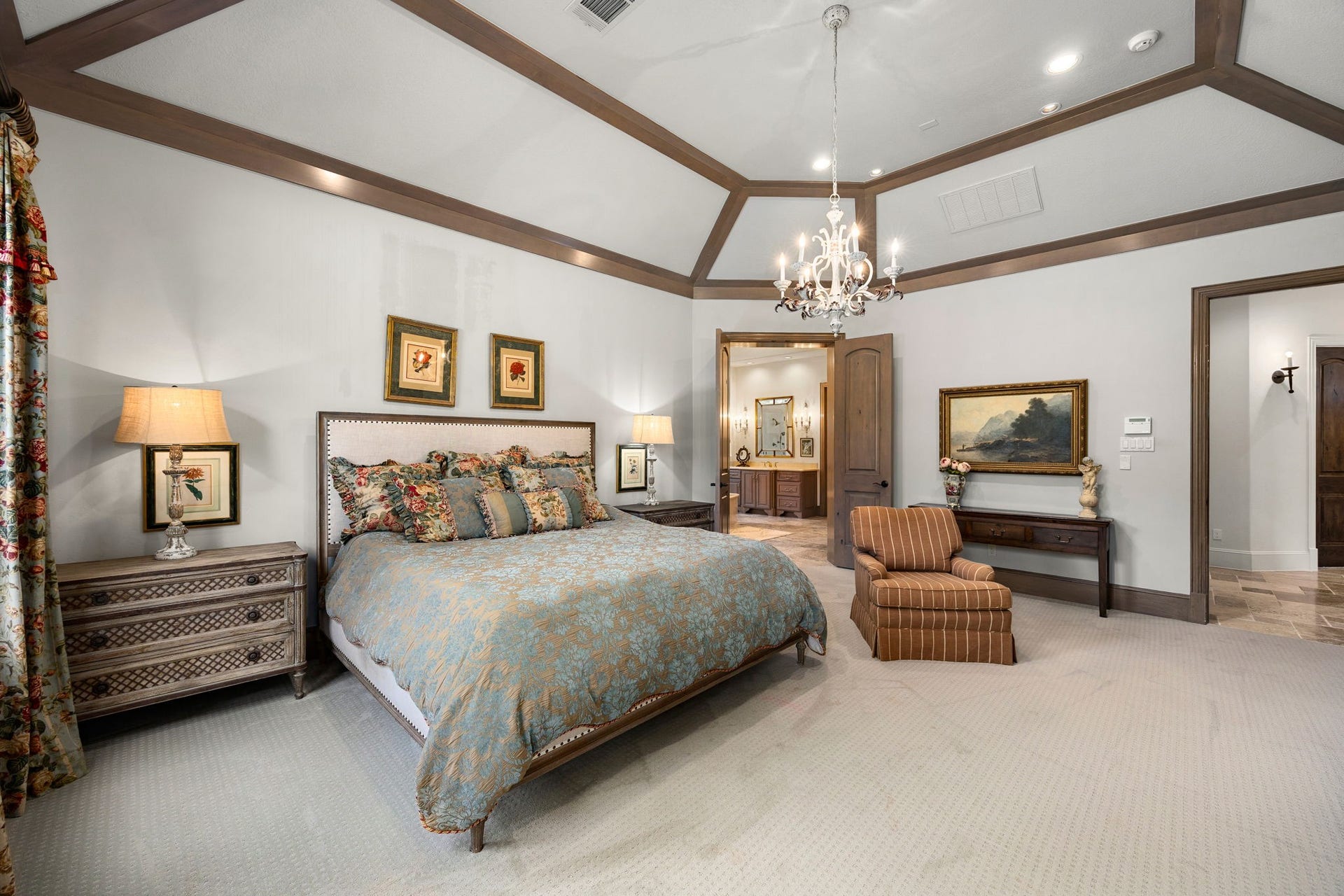 2127 Fawn Meadow Lane, Richmond, TX 77406 Generously sized primary bedroom featuring a tray ceiling and elegant architectural wood trim details.