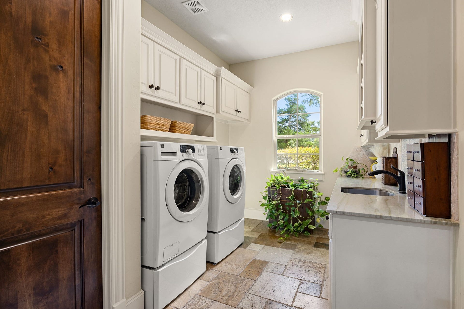 2127 Fawn Meadow Lane, Richmond, TX 77406 Laundry room featuring built-in cabinetry, utility sink, additional storage closet, countertop space, and room for full-size washer and dryer.