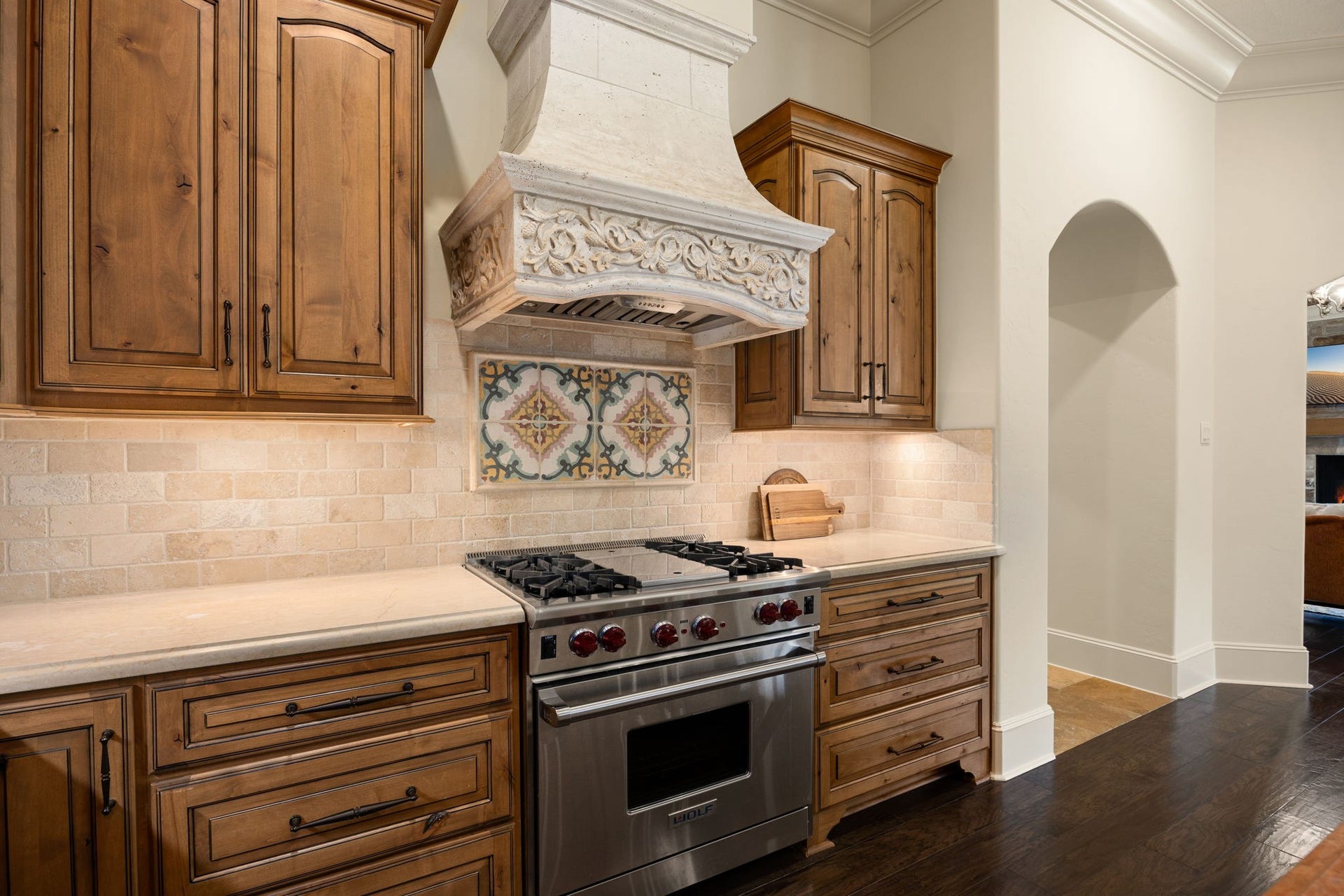 2127 Fawn Meadow Lane, Richmond, TX 77406 Kitchen cooking area featuring rich wood cabinetry, decorative backsplash, and stainless steel appliances.