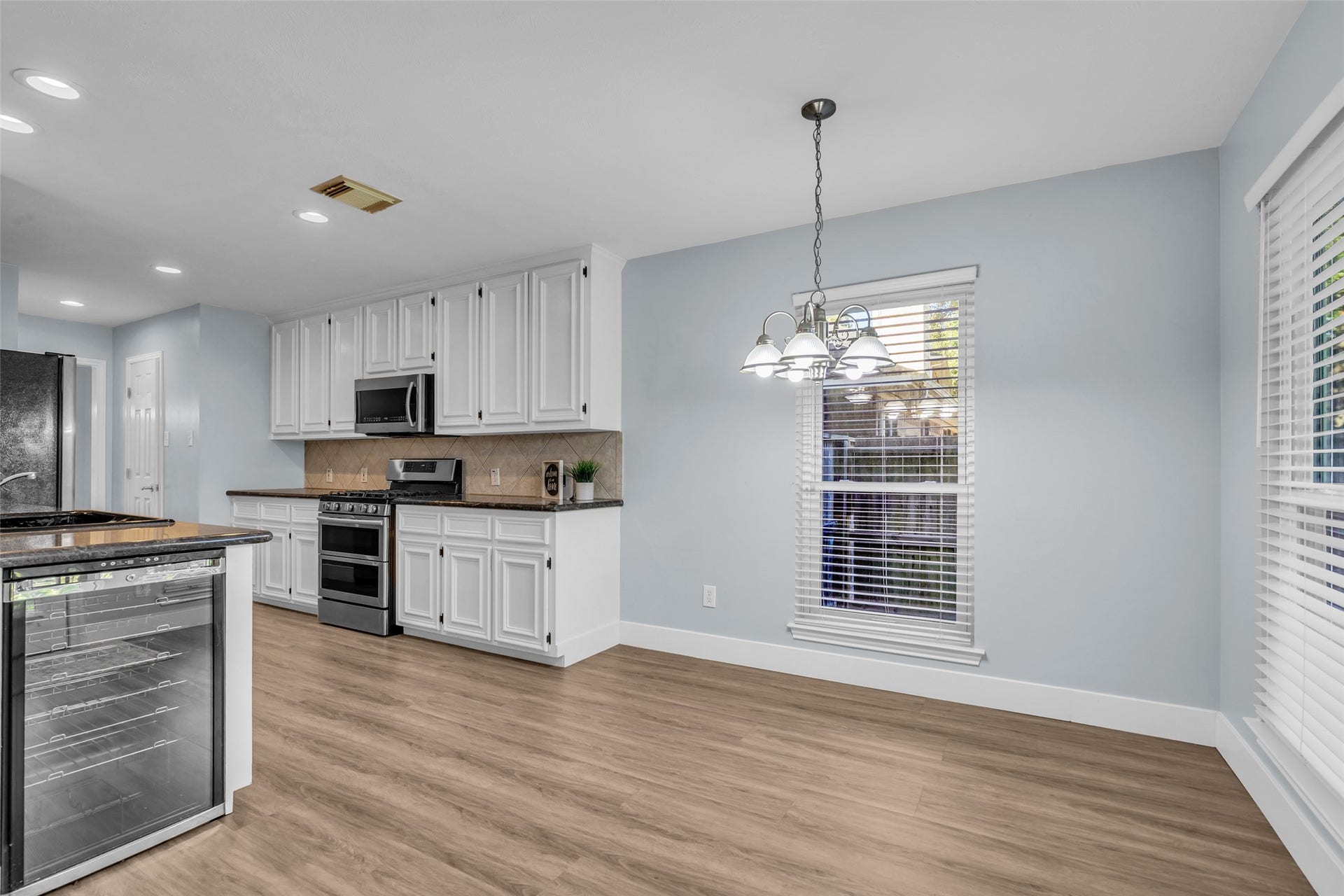 12722 Wolf Creek Court, Humble, TX 77346 Dining leads to kitchen with a dinnette area