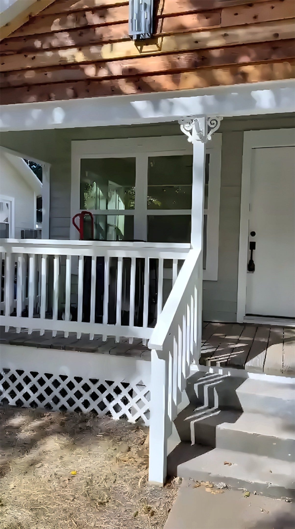 Front porch with white railing and steps