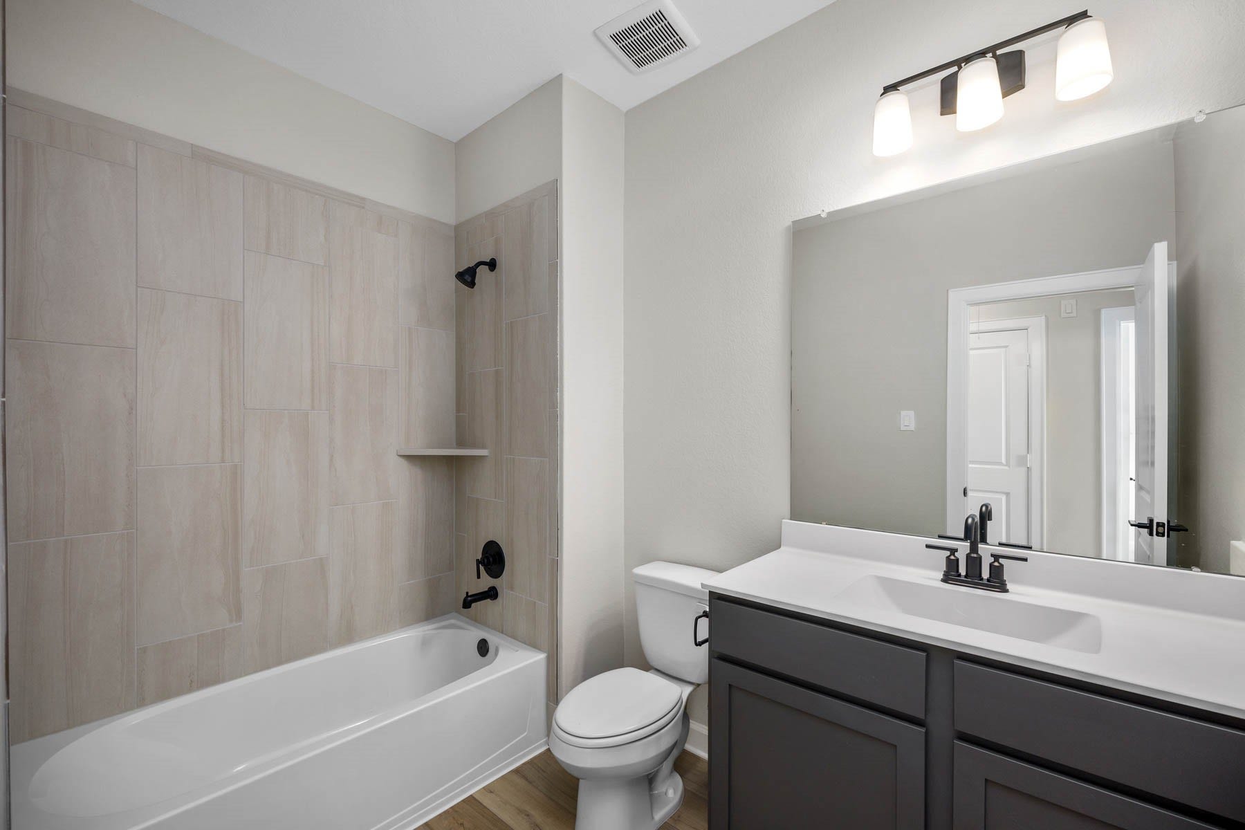 2921 Fair Wind Lane, Texas City, TX 77510 The secondary bathroom features upgraded lighting and tiled tub/shower surround.