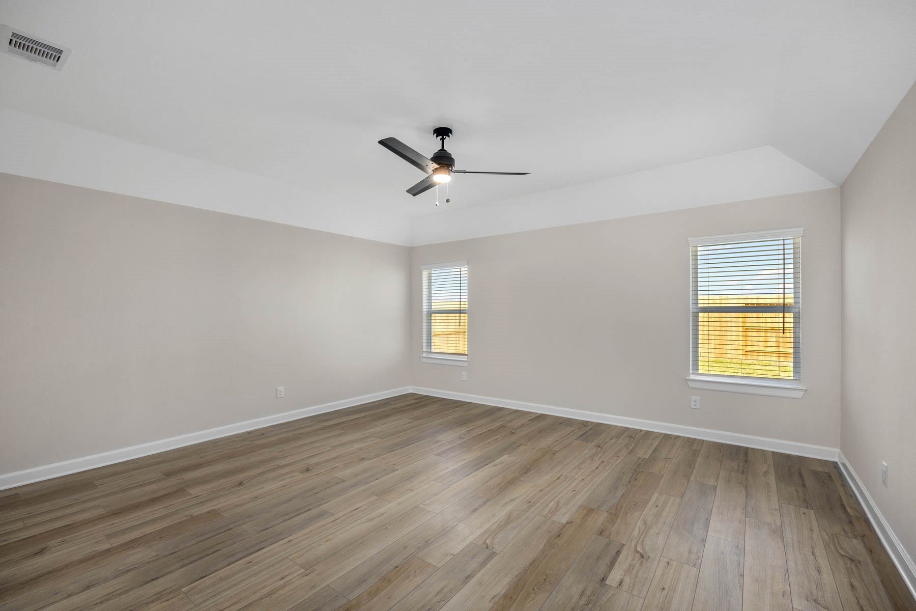 2921 Fair Wind Lane, Texas City, TX 77510 The spacious primary bedroom features luxury vinyl plank flooring and is the perfect place to unwind after a long day.