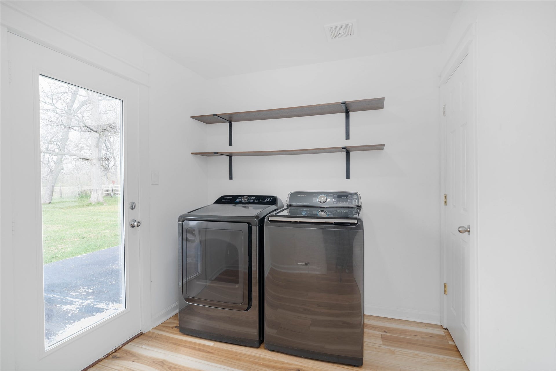 1635 Pony Lane, Wallis, TX 77485 Laundry Room Functional laundry room with built-in shelving and exterior door access.
