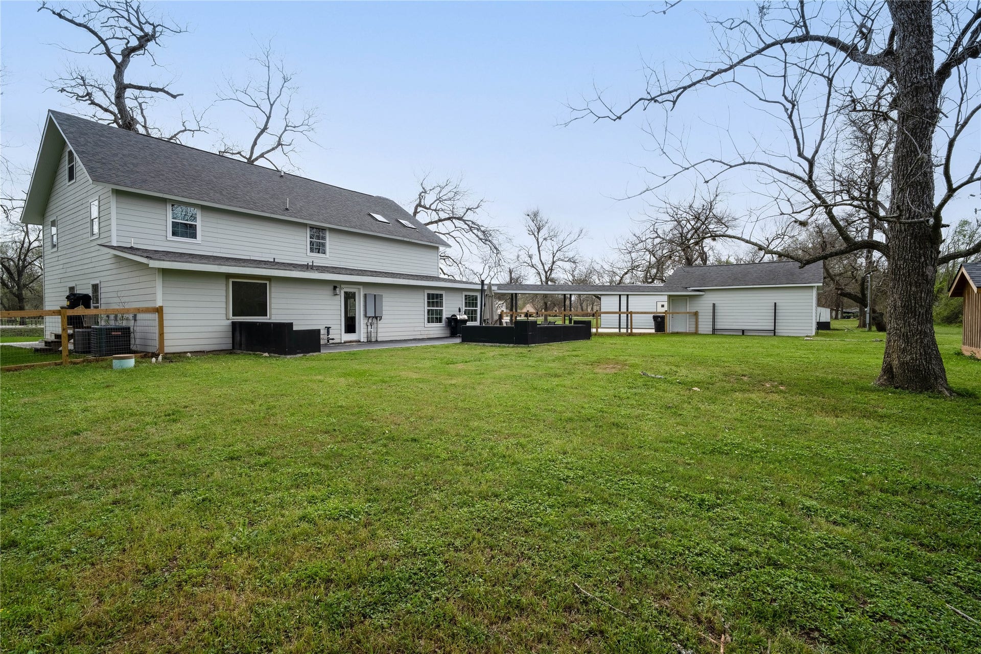 1635 Pony Lane, Wallis, TX 77485 Backyard / Rear Exterior Large backyard area with open green space and direct access to the rear patio, offering plenty of room for outdoor activities.