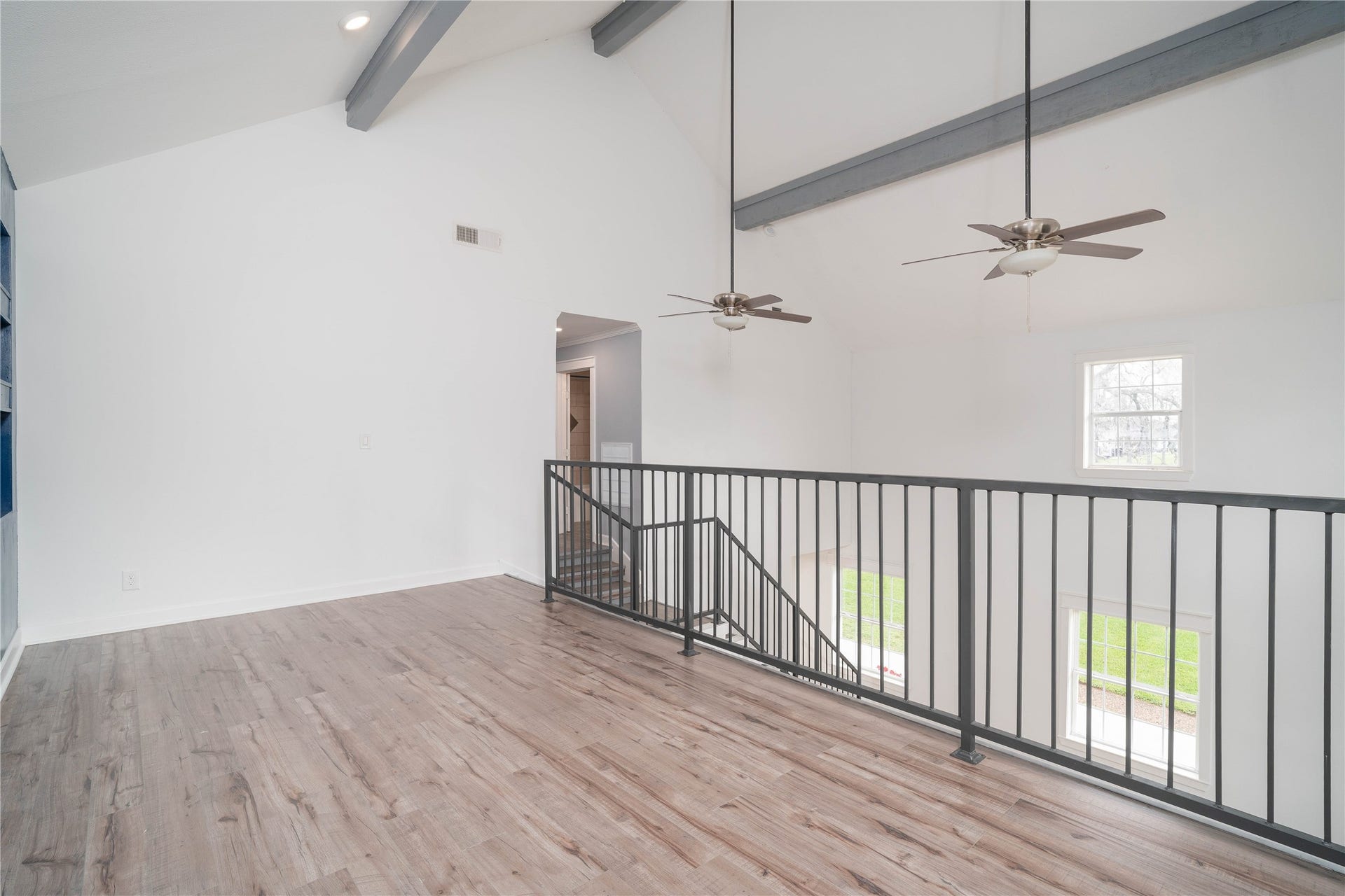 1635 Pony Lane, Wallis, TX 77485 Loft Overlook Open loft overlooking the main living space below, featuring modern railing and high ceilings that enhance the homes airy feel.