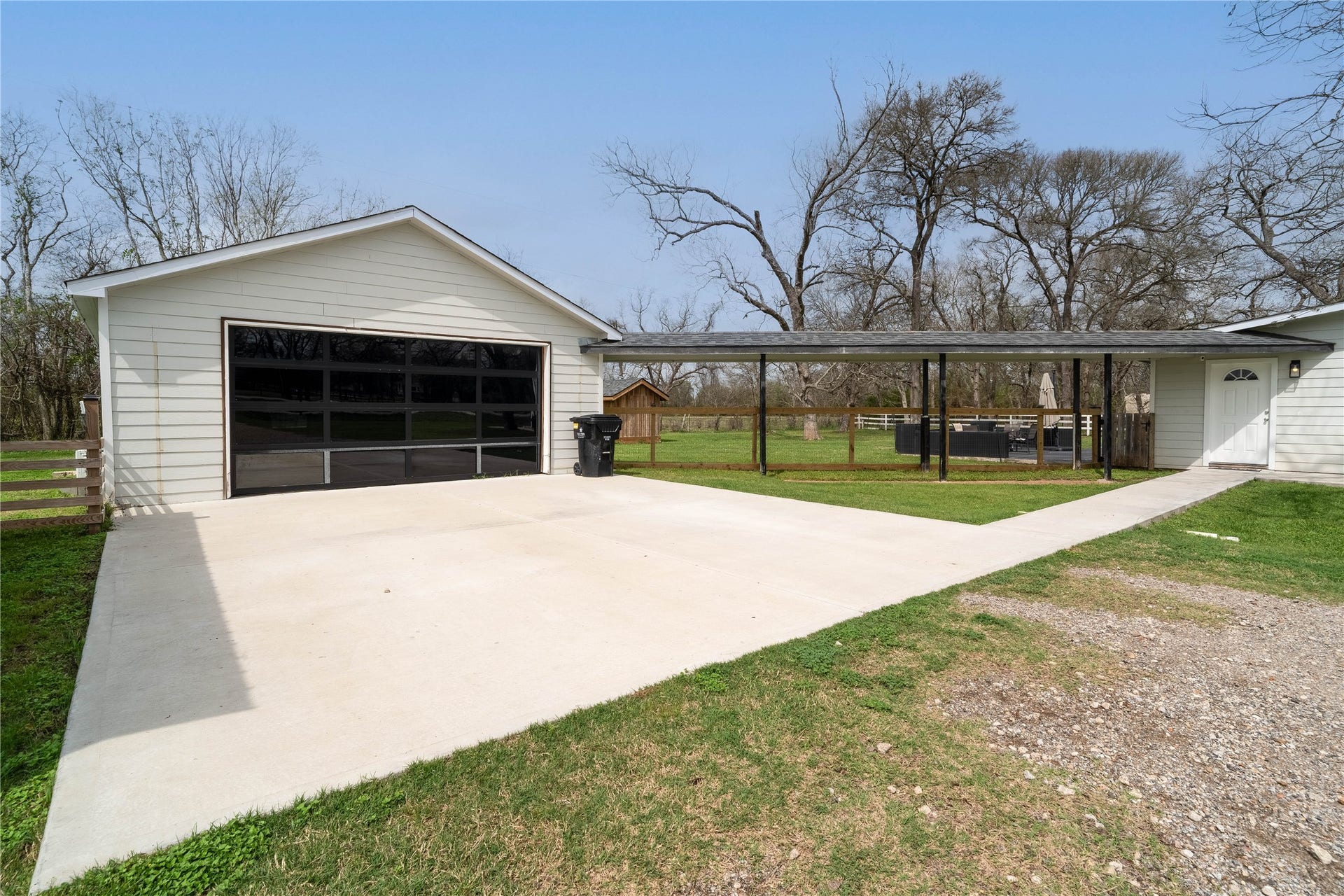 1635 Pony Lane, Wallis, TX 77485 Garage & Covered Walkway Detached garage with modern glass-style door and covered walkway.