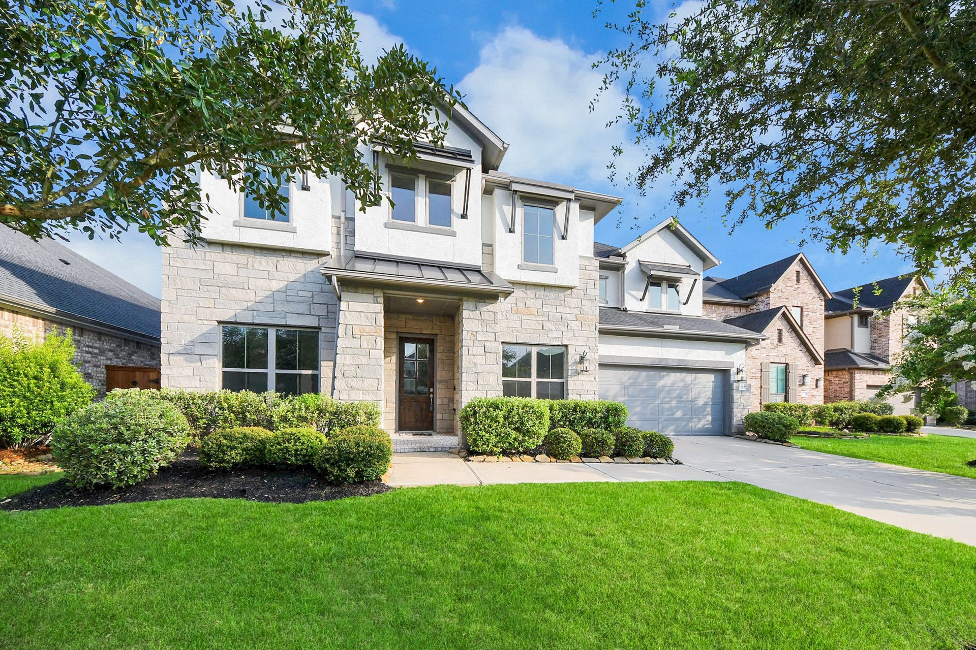 1714 Mccrae Hill Court, Katy, TX 77494 This stunning home boasts a spacious 3-car tandem garage, perfect for car enthusiasts or extra storage, all within an elegant exterior that promises charm and modern comfort.