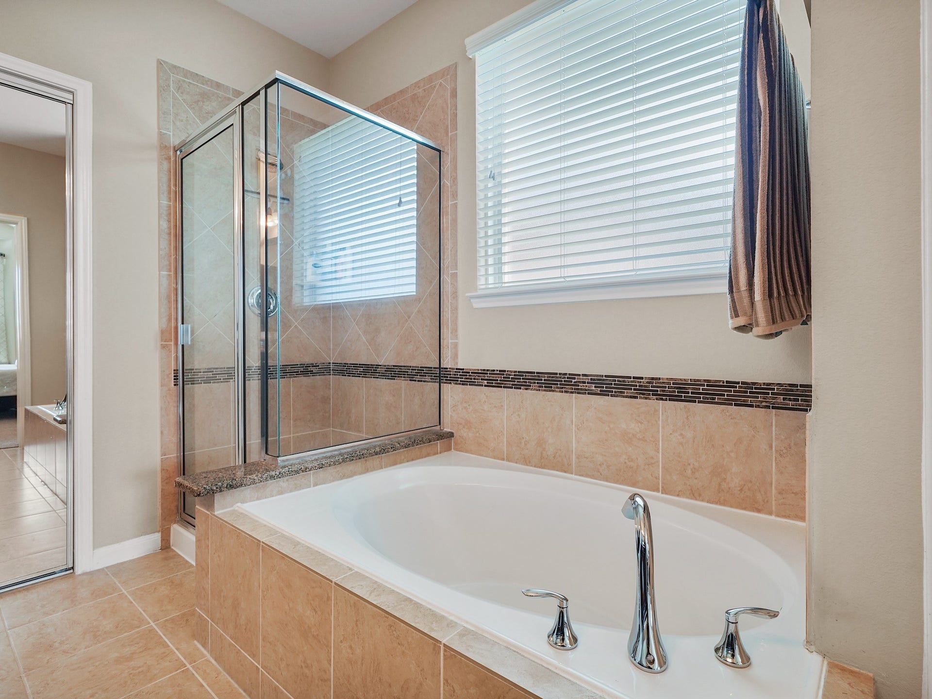3250 Bandera Run Lane, Katy, TX 77494 Settle into the soaking tub for a relaxing escape at the end of the day, while the separate glass-enclosed shower offers a refreshing way to start your morning. Together, they create a retreat for both quiet moments and everyday routines.