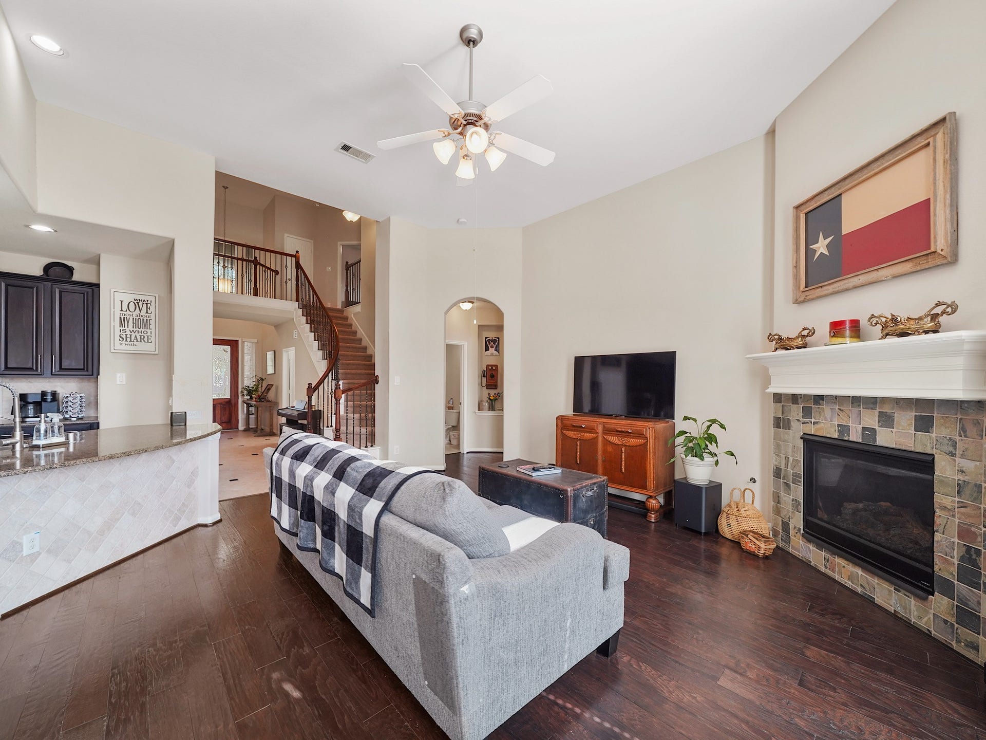 3250 Bandera Run Lane, Katy, TX 77494 Cozy up in this inviting living room featuring a stunning fireplace, perfect for relaxing evenings.