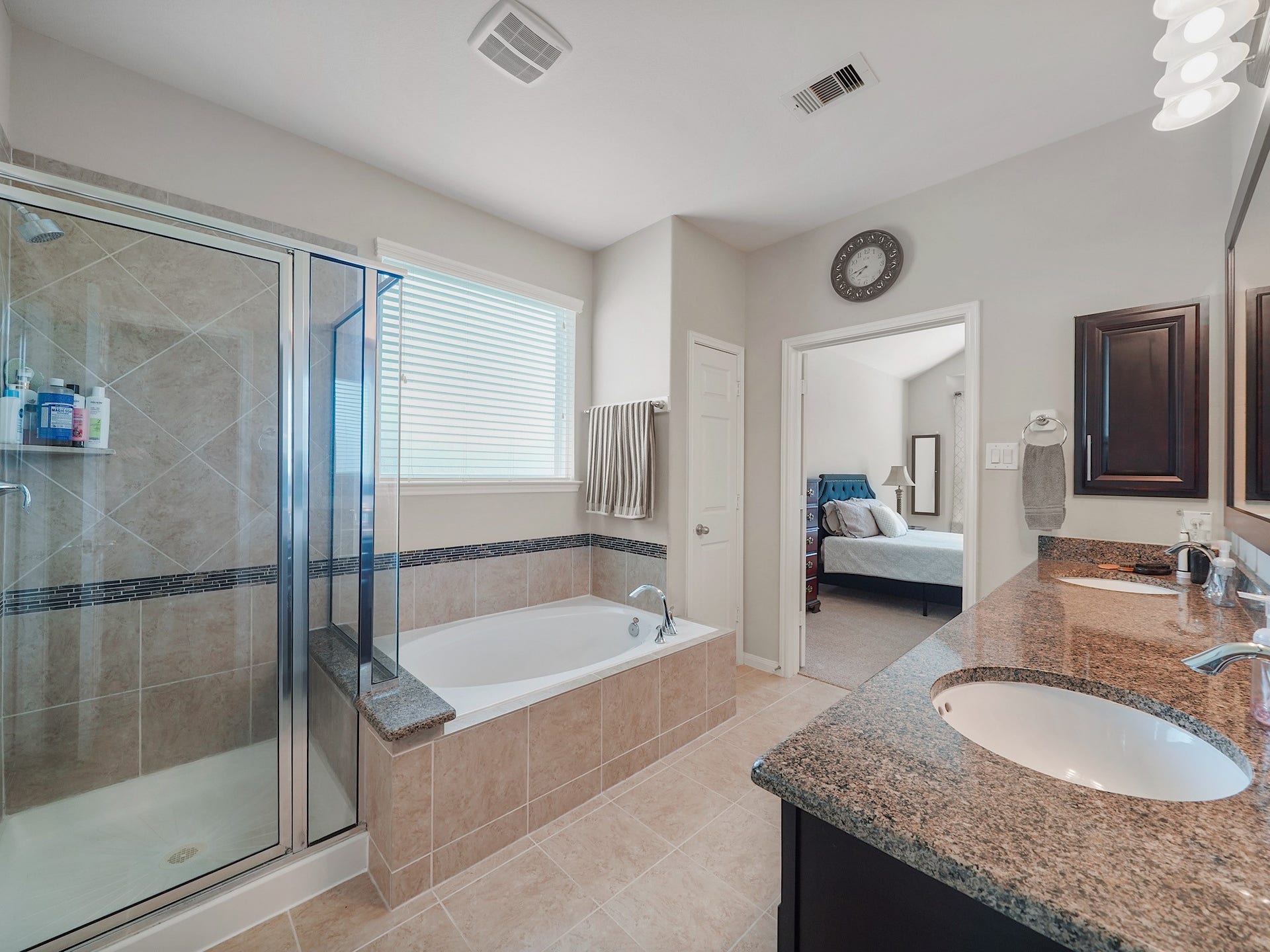 3250 Bandera Run Lane, Katy, TX 77494 The spacious primary bathroom offers a serene extension of the retreat, complete with a soaking tub, separate glass-enclosed shower, and an extended dual-sink vanity with granite countertops. Its a space designed to bring comfort and ease to your daily routine.