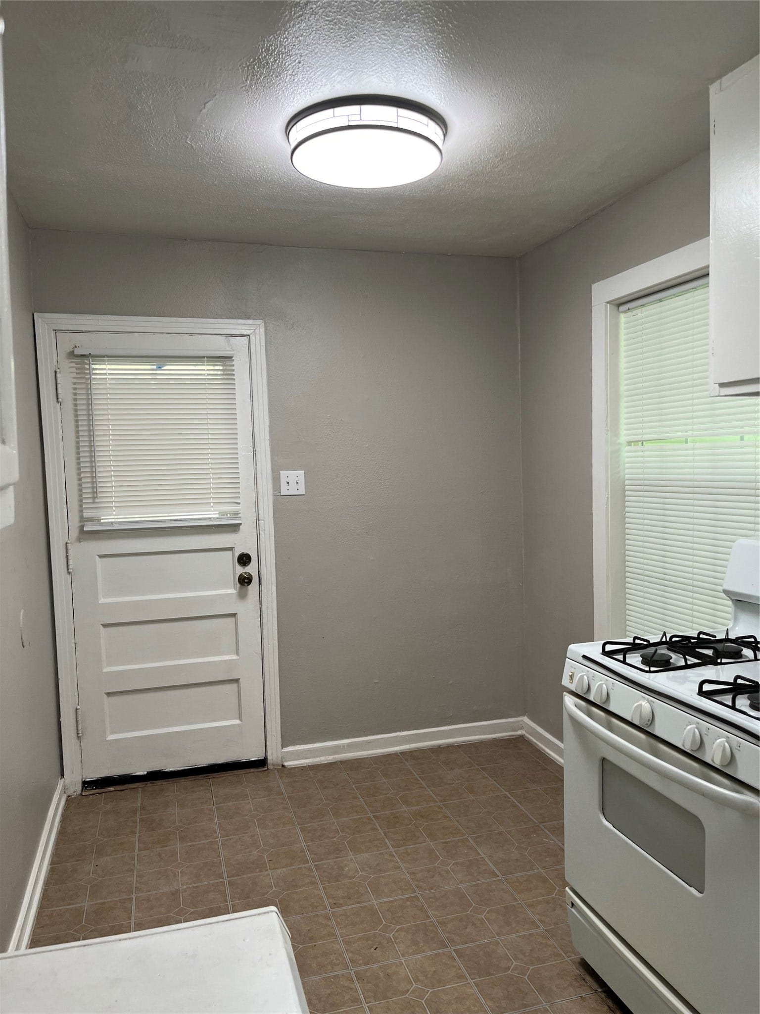 508 Honeysuckle Drive, La Marque, TX 77568 Breakfast area in the kitchen, door leads to old garage and storage area. Large window overlooks the large backyard