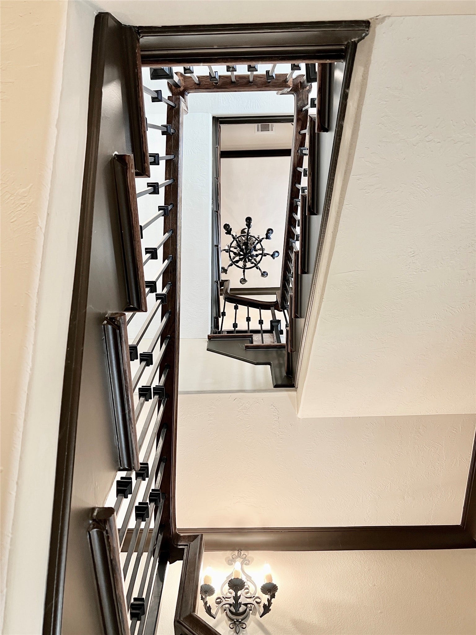 1241 W 24th Street, #C, Houston, TX 77008 Three story staircase is topped off with a large iron chandelier.