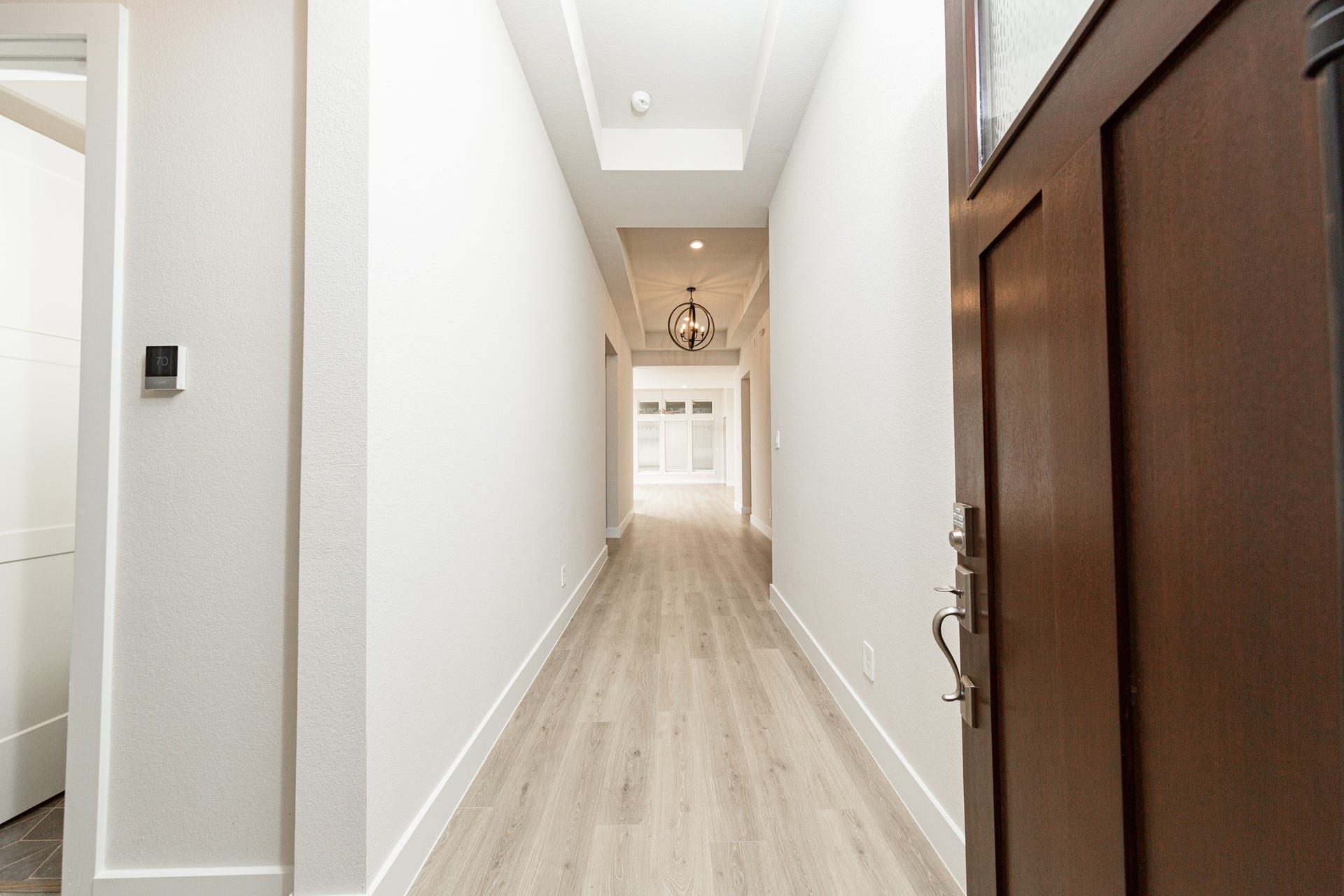 41422 Threadgill Way, Montgomery, TX 77316 An inviting entrance opens up to an open-concept layout, seamlessly connecting the entry to the living areas with durable wood look tile flooring and striking architectural details.