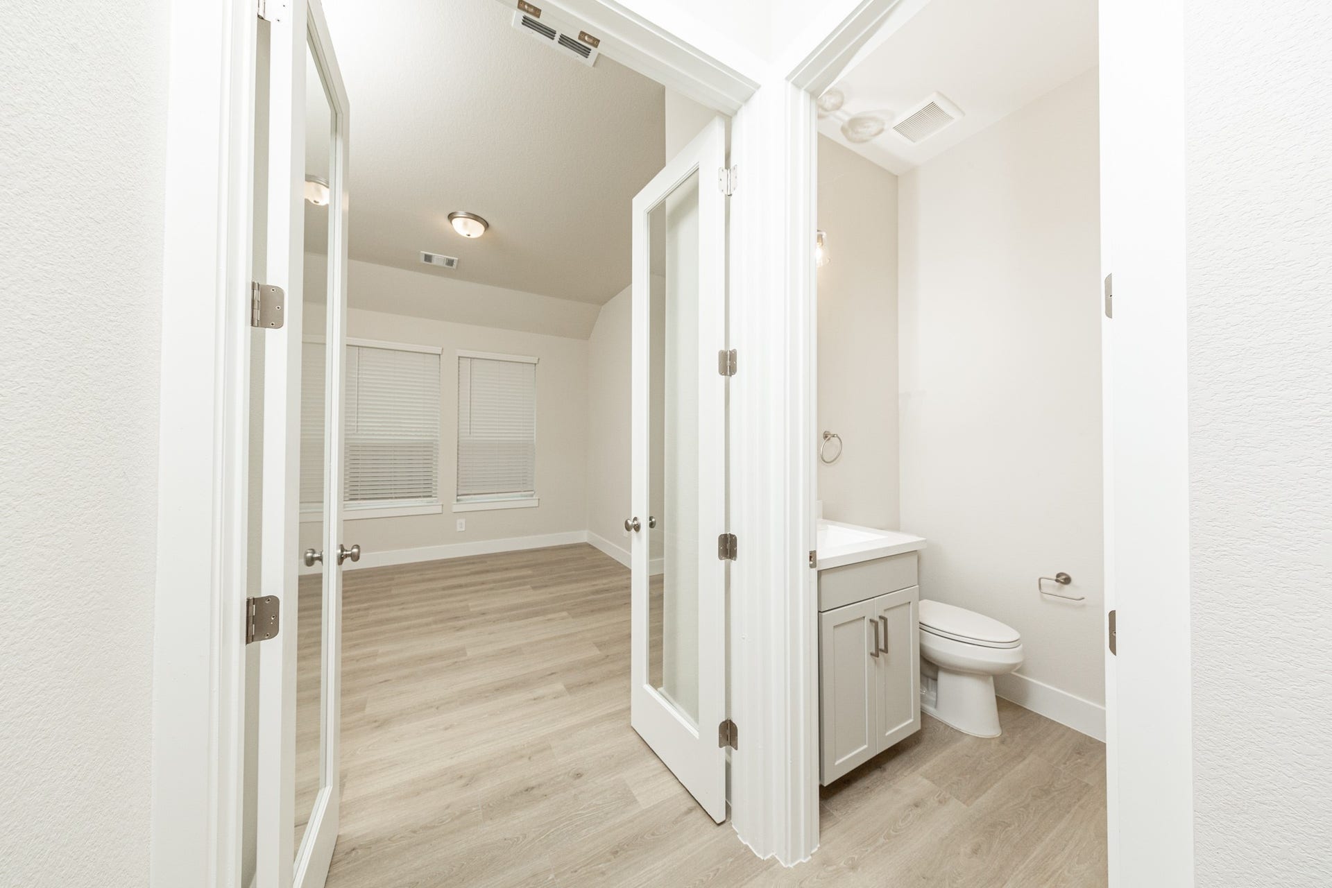 41422 Threadgill Way, Montgomery, TX 77316 The powder bath is located conveniently near the study! The study features elegant glass French doors that allow natural light to flow seamlessly into the main living areas while maintaining quiet separation.
