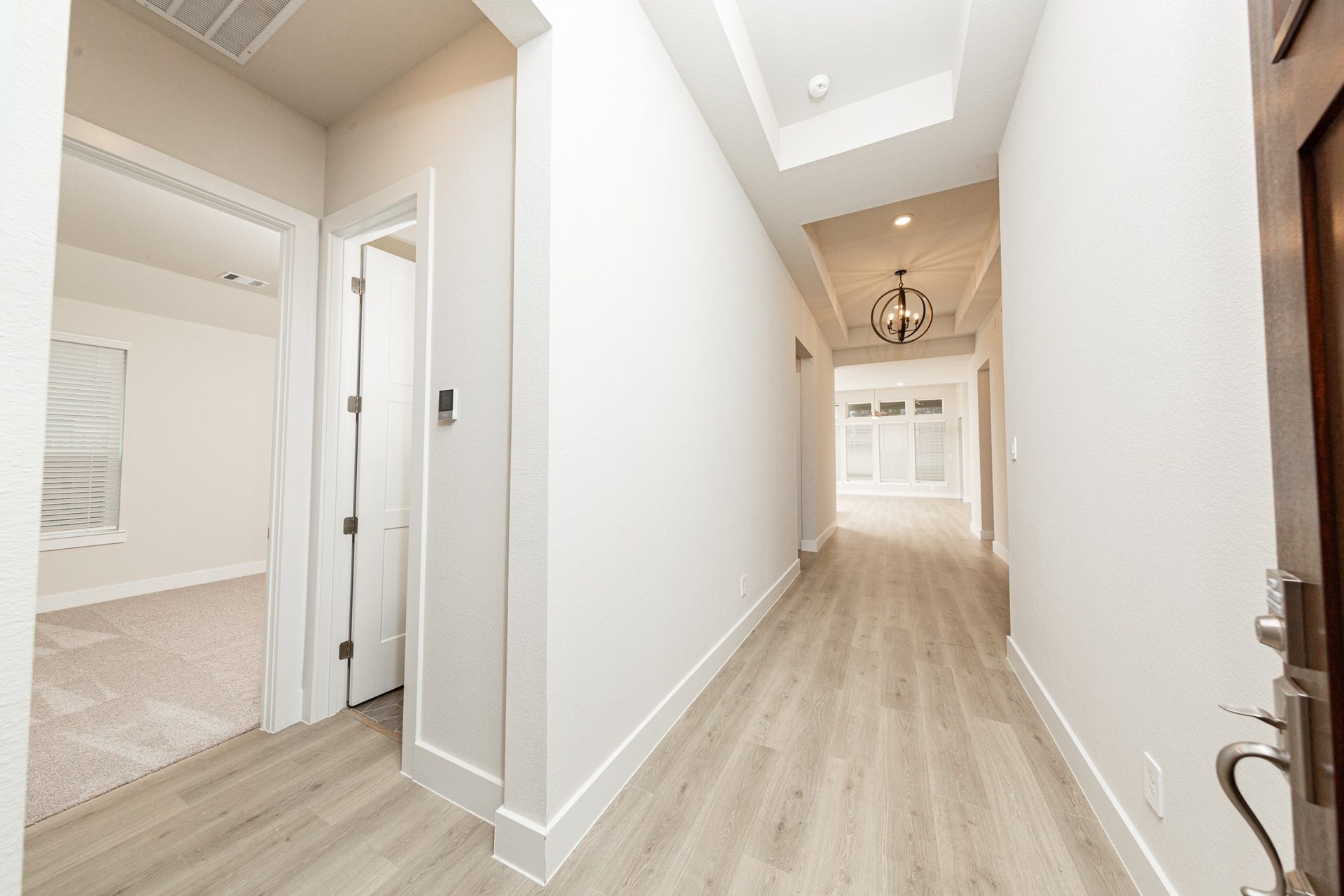 41422 Threadgill Way, Montgomery, TX 77316 The grand entryway sets an elegant and inviting tone for the home, designed to make a strong first impression. The entryway is illuminated by a stunning black iron orb chandelier, which serves as a significant focal point.