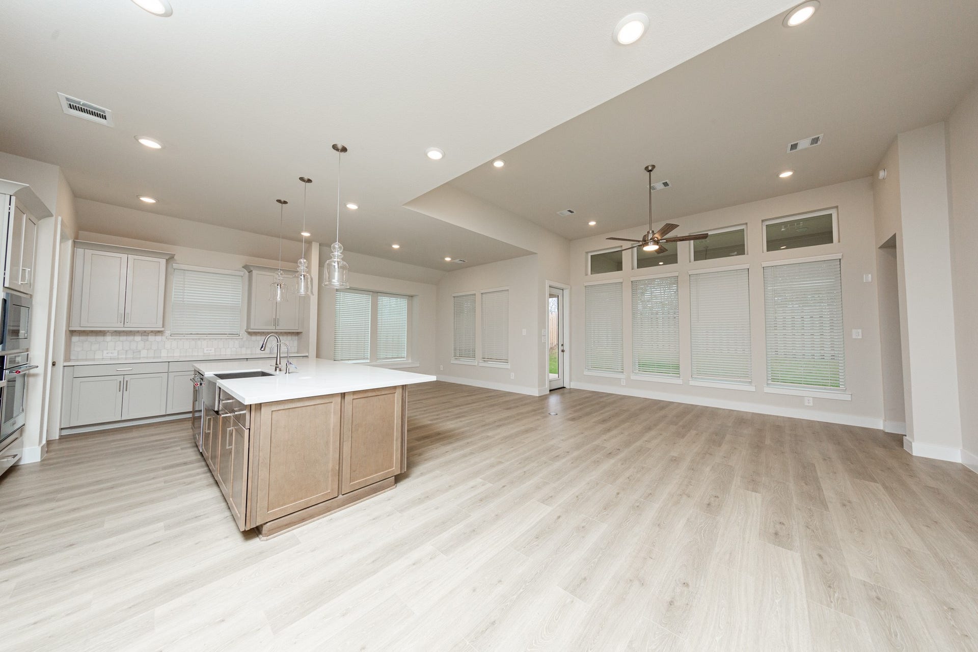 41422 Threadgill Way, Montgomery, TX 77316 Enjoy a seamless flow between the living, dining and kitchen areas, perfect for entertaining. Access the tranquil outdoors through a modern, full-lite glass patio door which provides abundant natural light and an open view of the private fenced backyard.