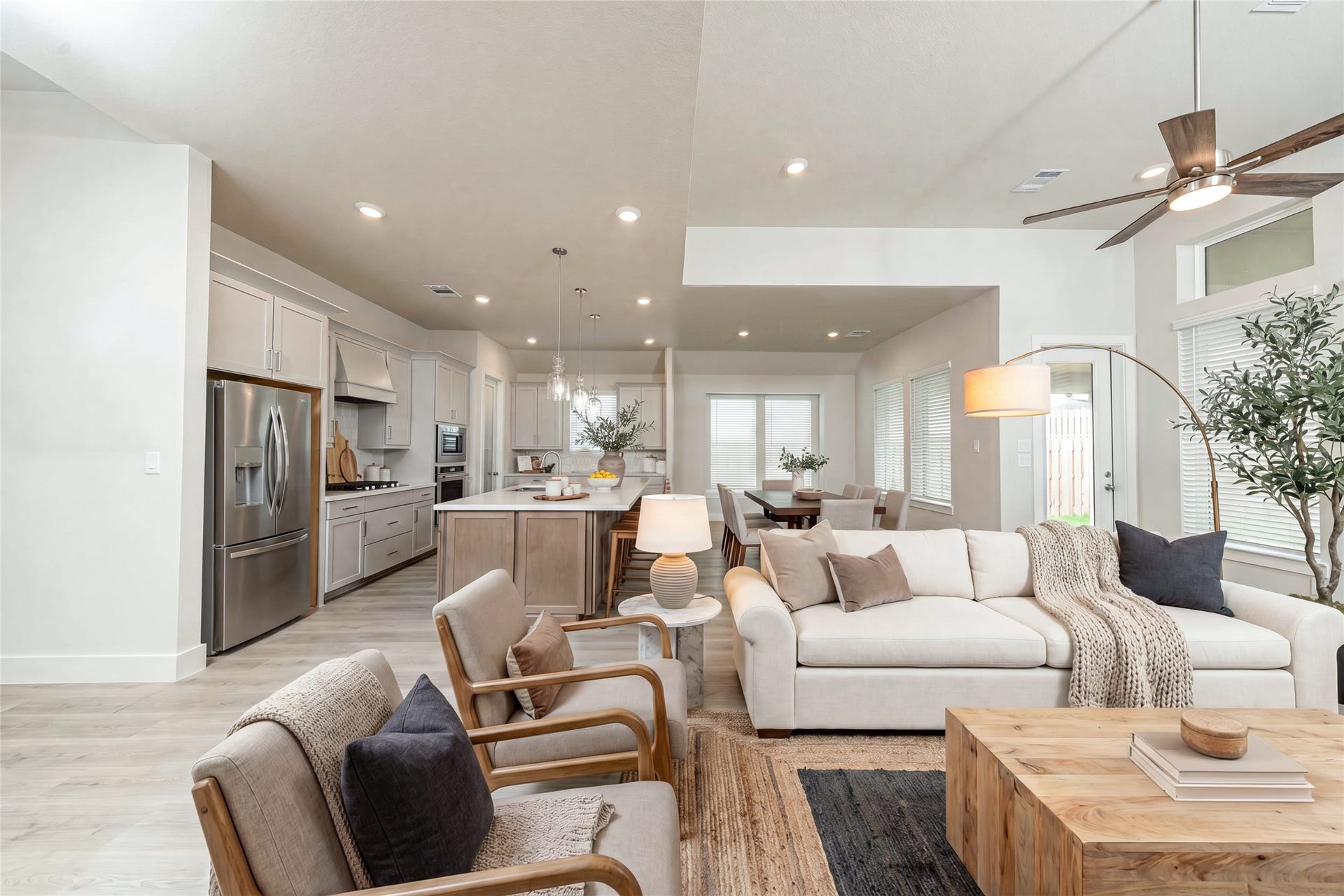 41422 Threadgill Way, Montgomery, TX 77316 Open concept living with the living, kitchen and dining areas - all filled with natural light and featuring high ceilings, recessed lighting, and expansive windows. *Virtually Staged.