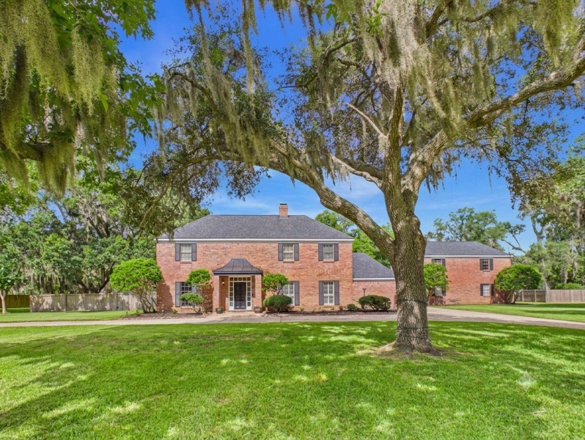 111 Cherrywood Dr, Lake Jackson, TX 77566 Front of the property with live oaks and pecan trees