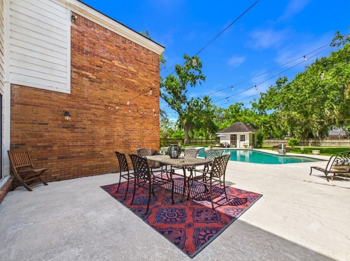 111 Cherrywood Dr, Lake Jackson, TX 77566 Back patio with sitting area looking at backyard and pool