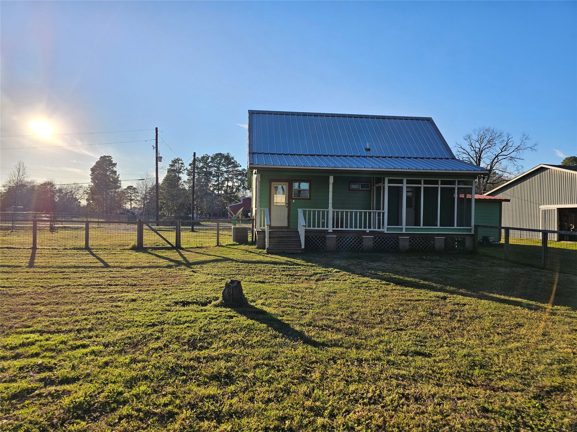25411 T K C Road, Tomball, TX 77375 View of the screened-in back porch and backyard