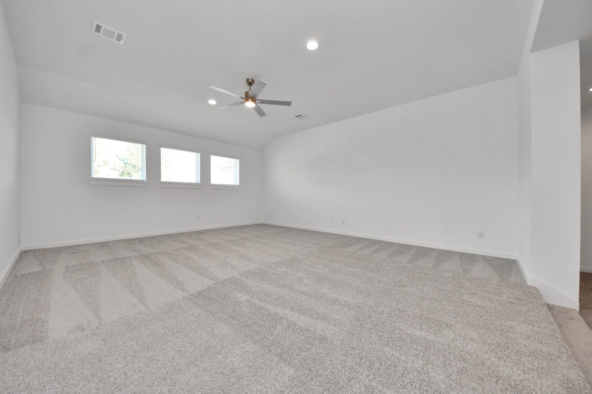 2097 Corn Thistle Way, Magnolia, TX 77355 Discover a haven of leisure in this fantastic game room! Whether you're seeking a casual hangout or an adult gaming retreat, this space has it all. Enjoy the luxurious feel of plush carpet underfoot, the expansive ambiance of high ceilings, custom paint that adds a touch of personality, and windows that flood the room with refreshing natural light.