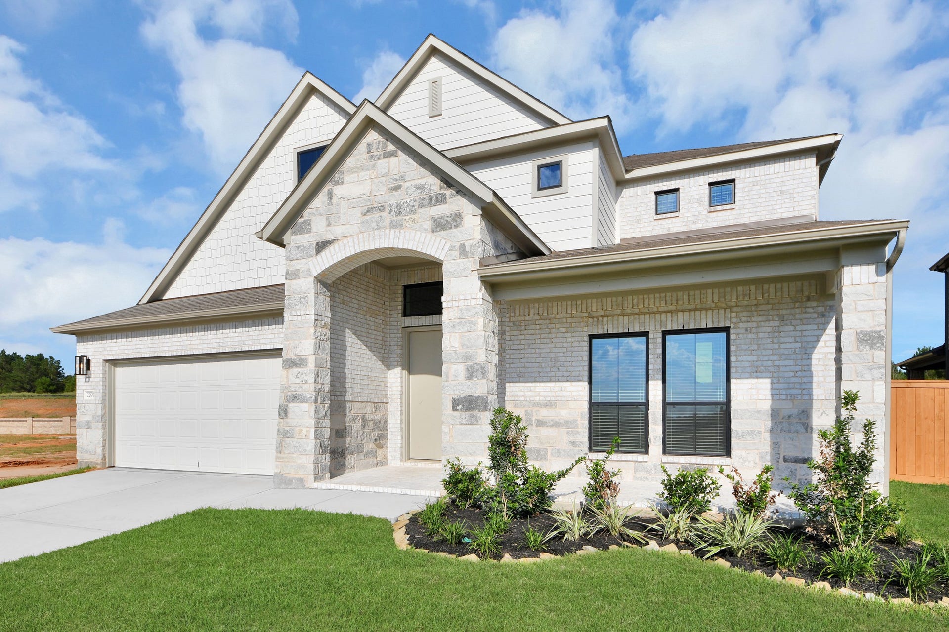 2097 Corn Thistle Way, Magnolia, TX 77355 Home features a convenient 2-car garage complemented by a spacious driveway, offering ample parking for you and your guests.