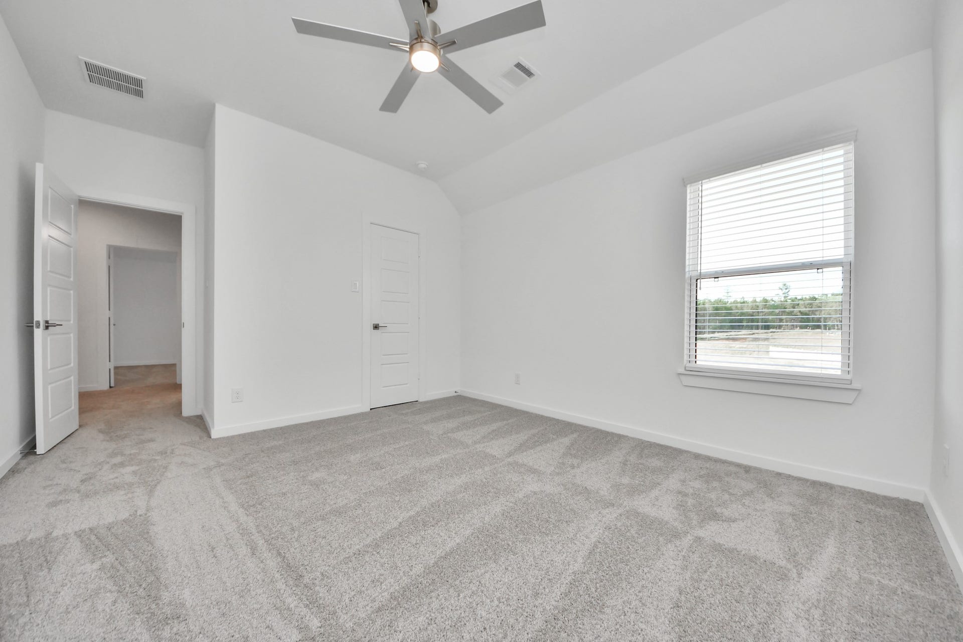 2097 Corn Thistle Way, Magnolia, TX 77355 Generously sized secondary bedrooms featuring spacious closets, soft and inviting carpeting underfoot, large windows allowing plenty of natural light, and the added touch of privacy blinds for your personal retreat.