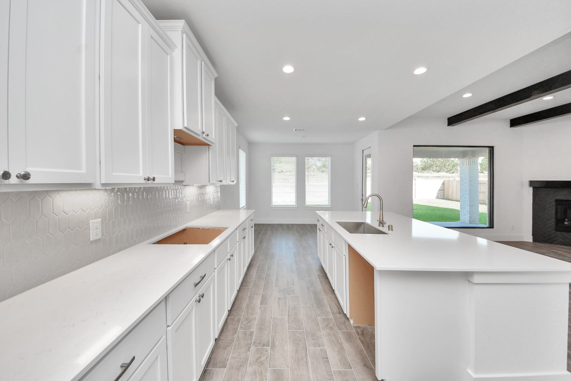 2097 Corn Thistle Way, Magnolia, TX 77355 This kitchen is by far any chefs dream! This spacious kitchen features high ceilings, stained wood cabinets, granite countertop, SS appliances, modern tile backsplash, recessed lighting, extended counter space, granite kitchen island with double sink, and space for breakfast bar, and a walk-in pantry all overlooking your huge family room.
