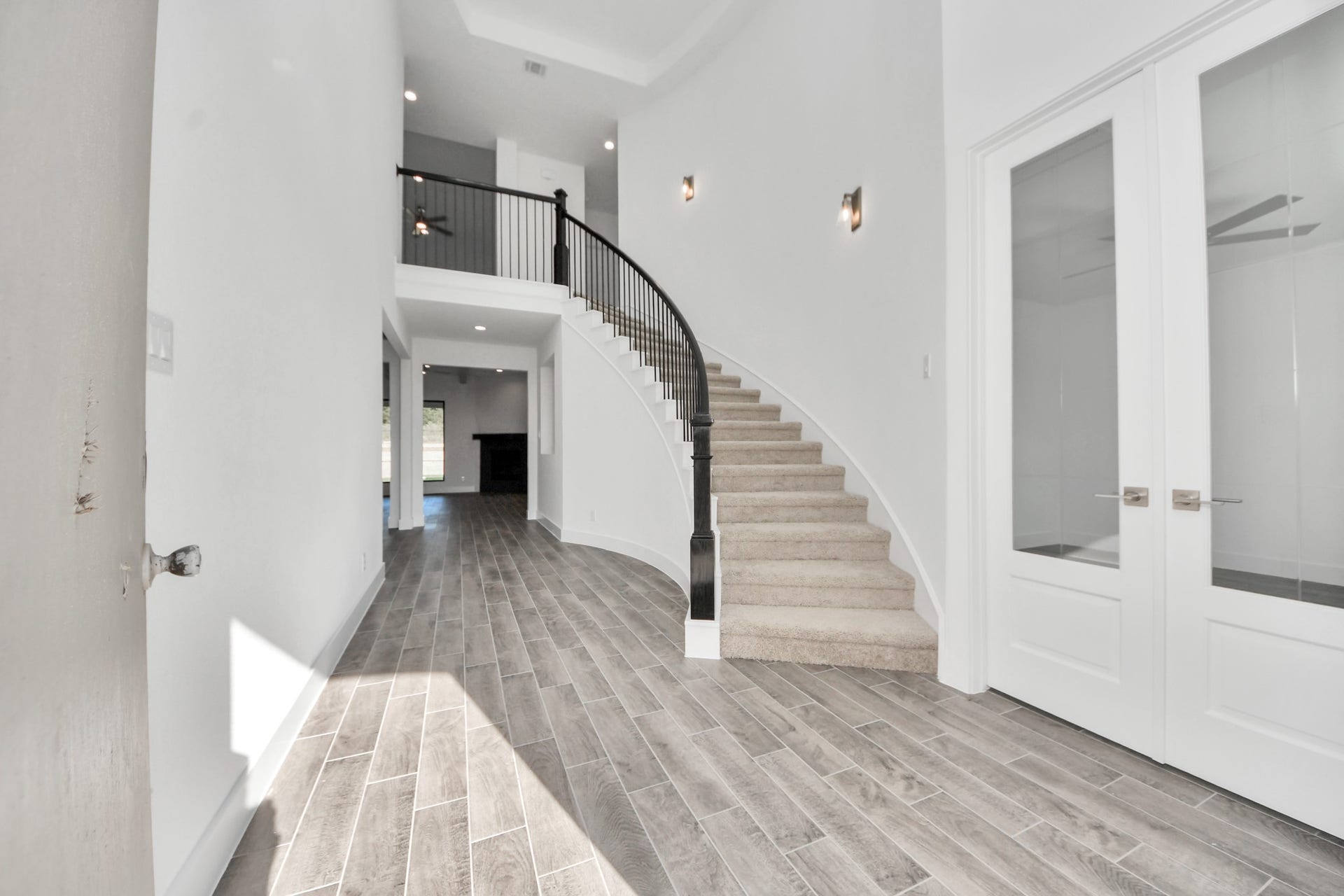 2097 Corn Thistle Way, Magnolia, TX 77355 As you step into the threshold of this luxurious home, you'll soon be welcomed by an elegant glass door (to be installed). Inside, soaring ceilings amplify the spaciousness, while the refined wood-look tile flooring and oversized baseboards exude sophistication and charm.